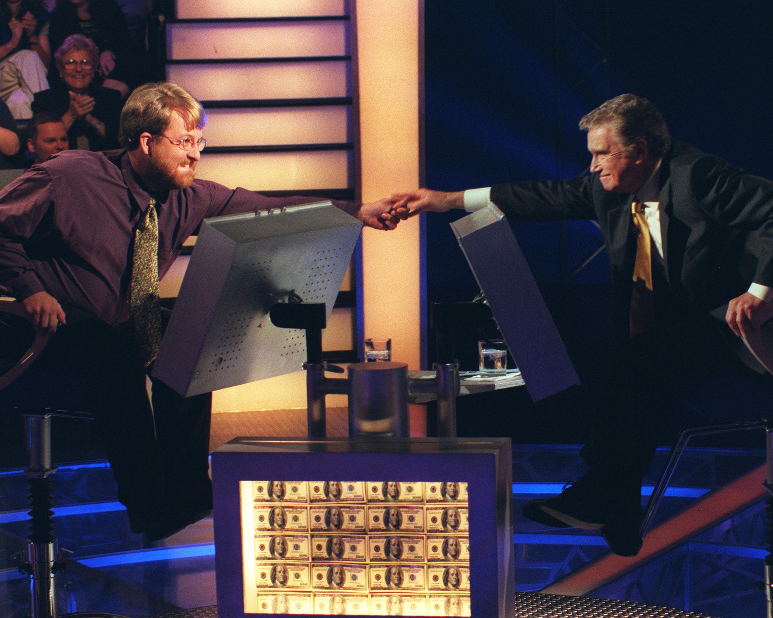 Host Regis Philbin and contestant Doug Van Gundy, from Marlinton, West Virginia, in 1999.