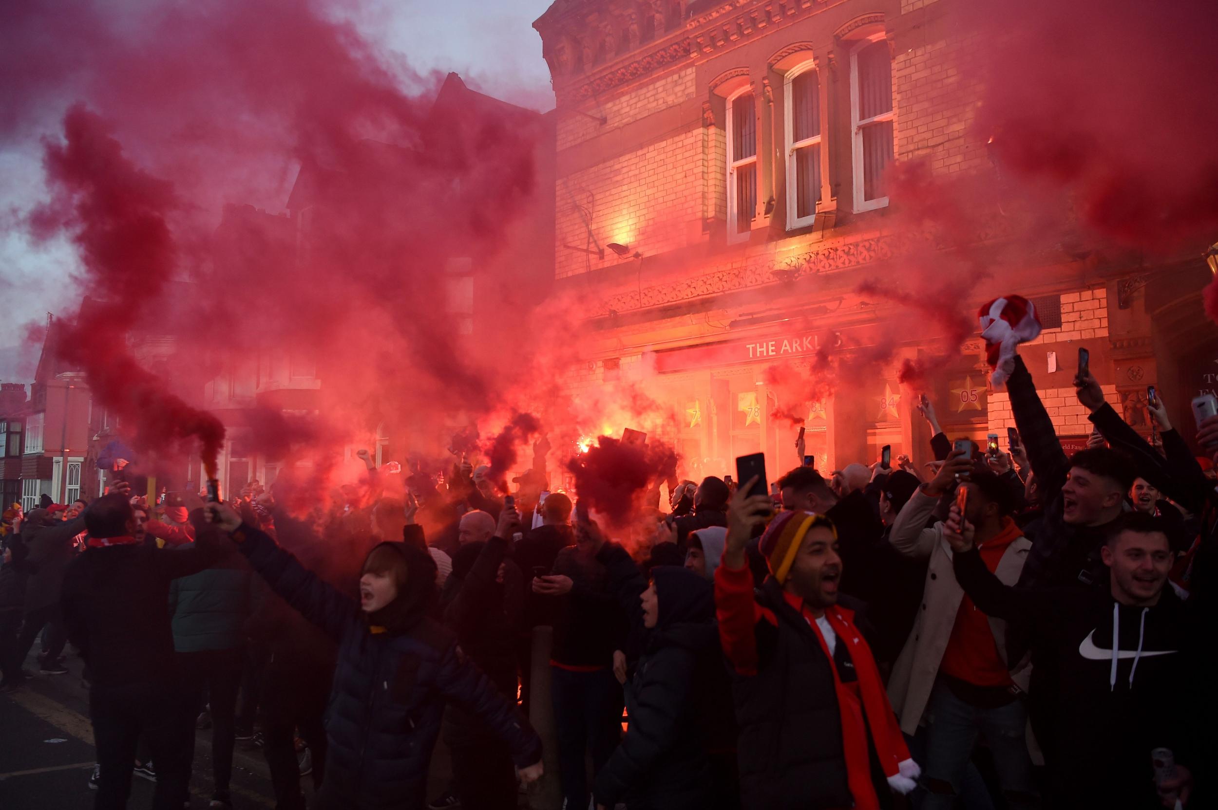 Liverpool fans light flares outside Anfield before the game (Getty)