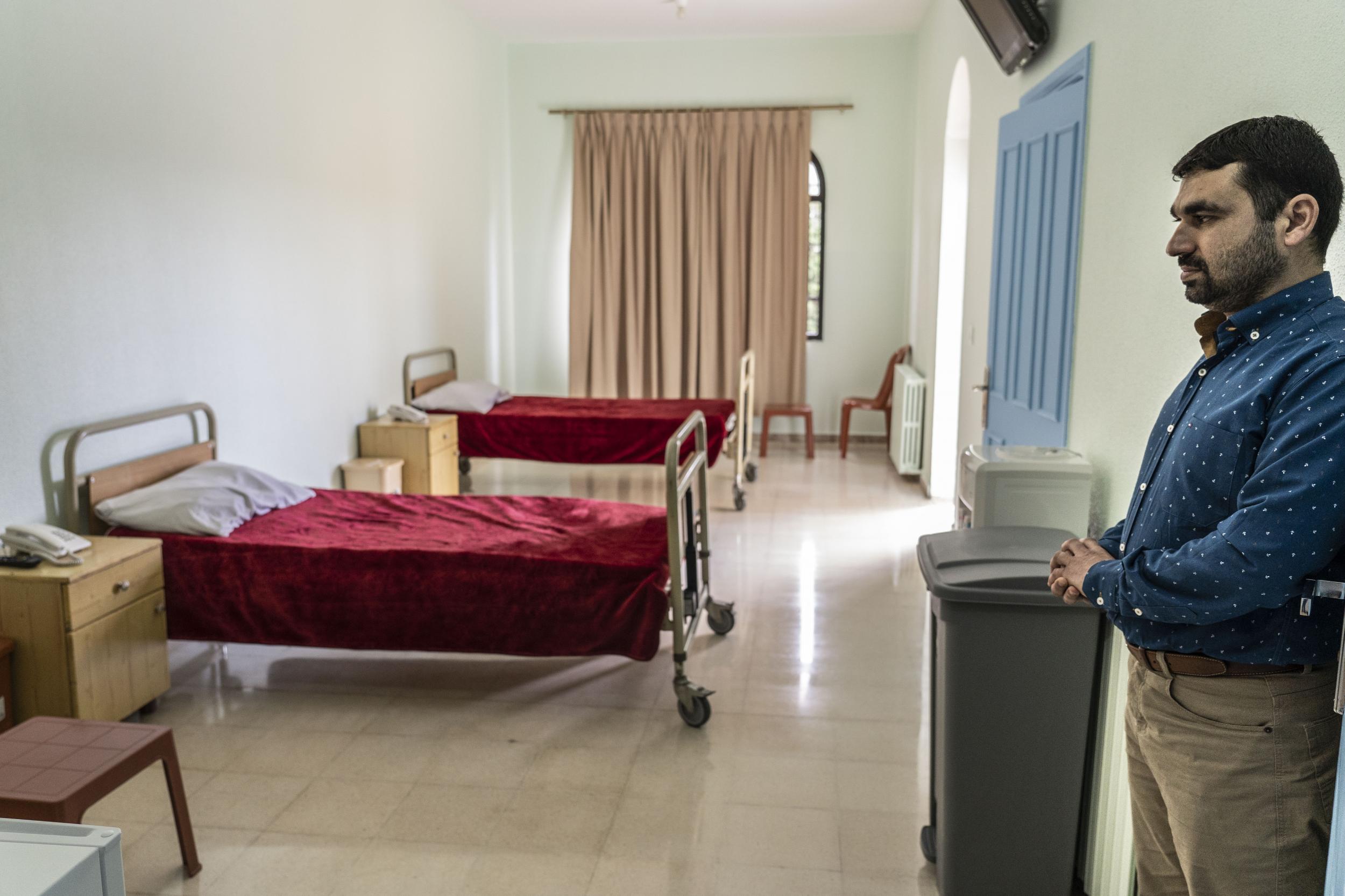 A Hezbollah representative shows one of the isolation rooms of the group’s new coronavirus wards