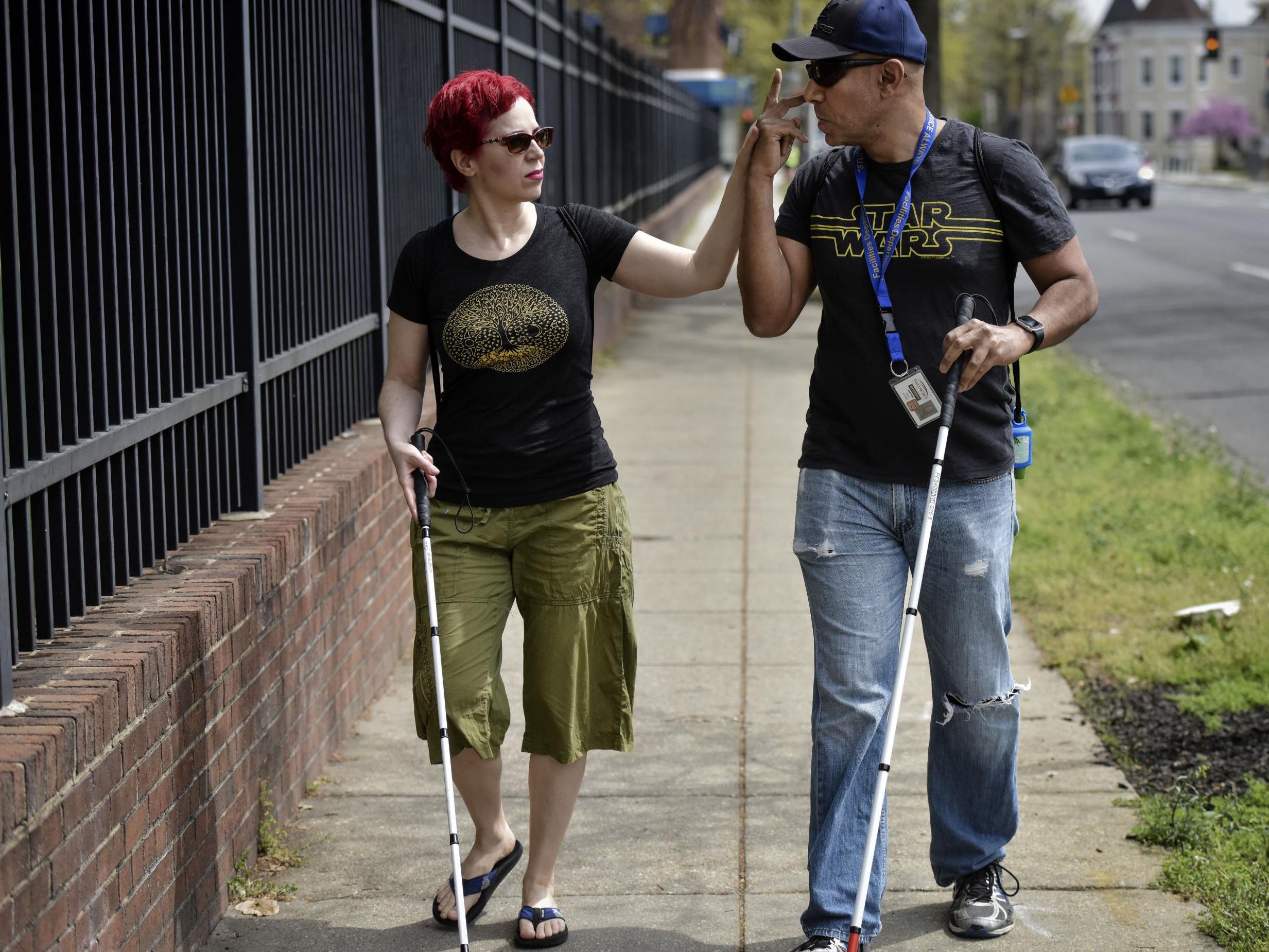 Reis and Gonzalez communicate by touch as they walk (The Washington Post)