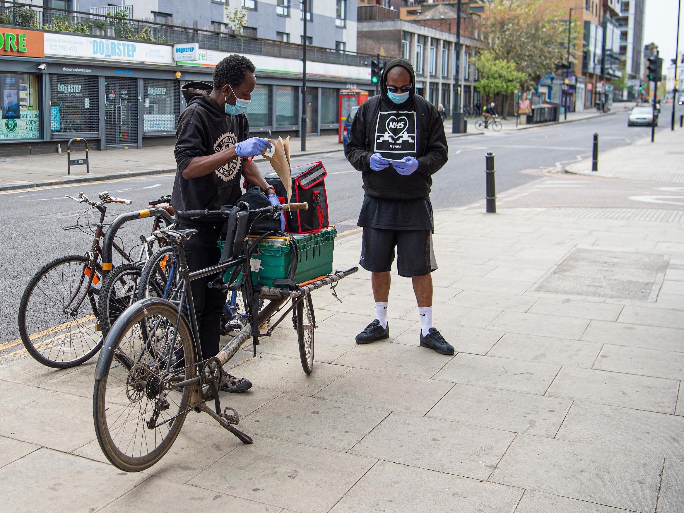 Patrick Williams (right) delivering food with fellow volunteer Clarence Chodokufa