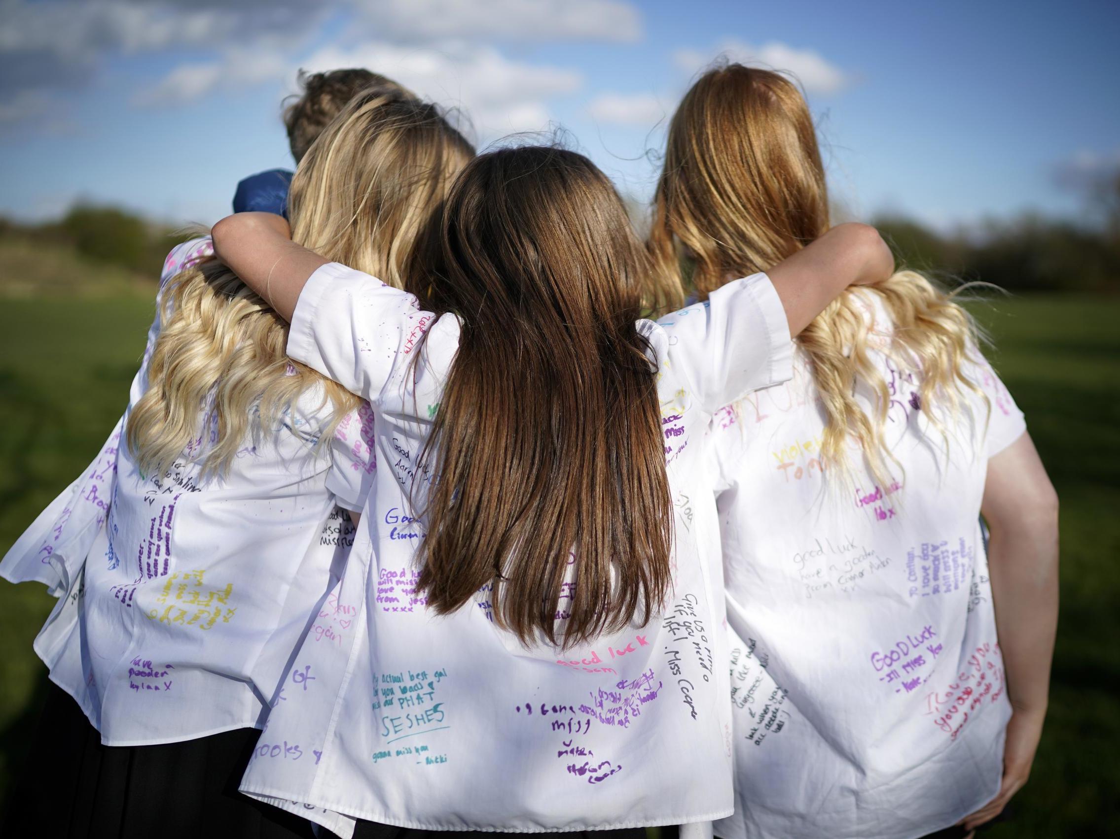 Senior schoolchildren embrace and mark their 'leavers'' day early as they head home and schools are closed due to the ongoing coronavirus pandemic on 20 March 2020 in Northwich England