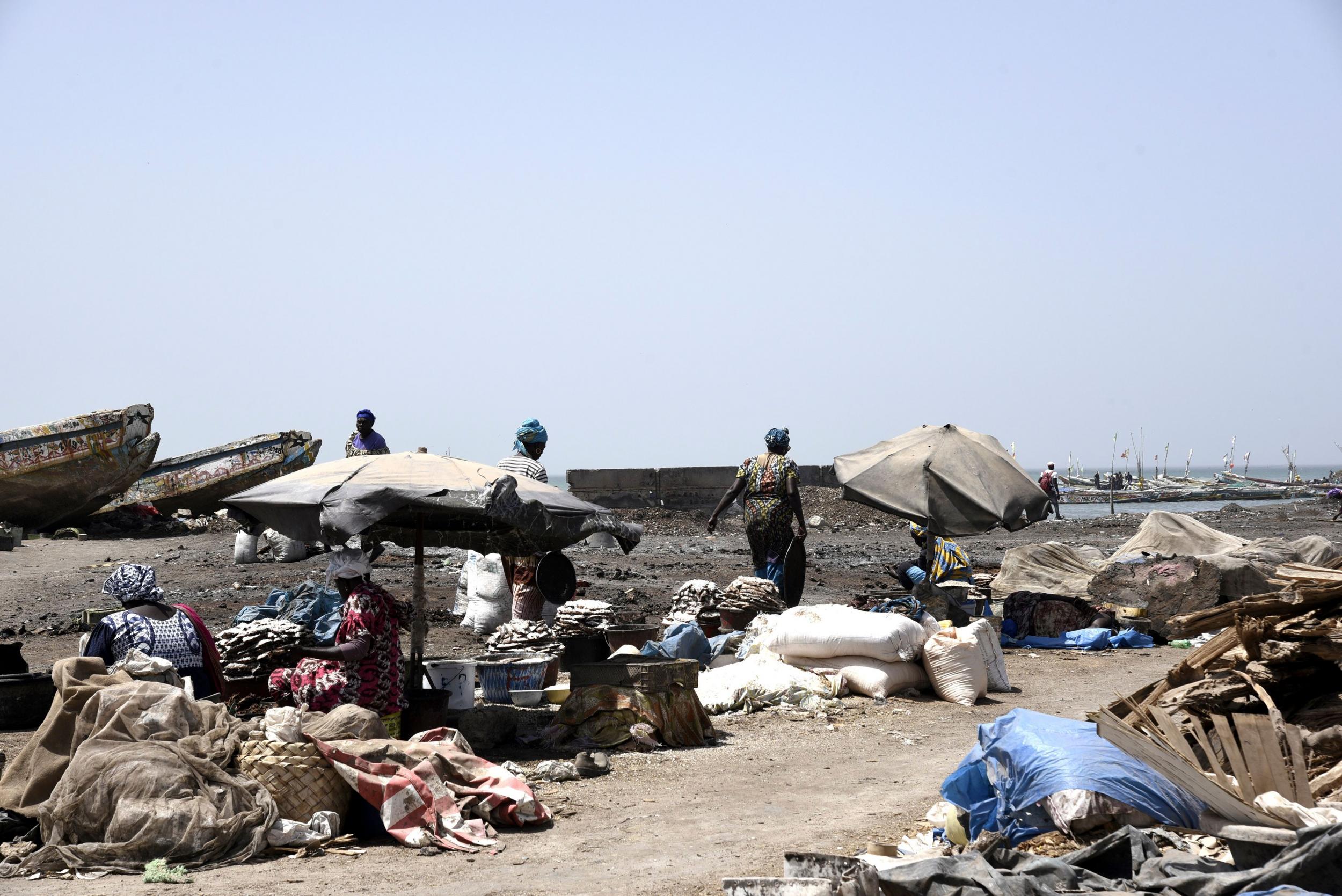 Women walk past stalls at the deserted fish market in Rufisque, Senegal, as hunger is predicted to be hit hardest by coronavirus in Africa