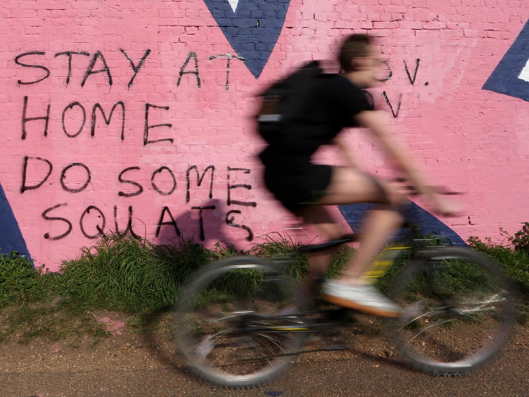 A cyclist riding through the Olympic Park in London during lockdown