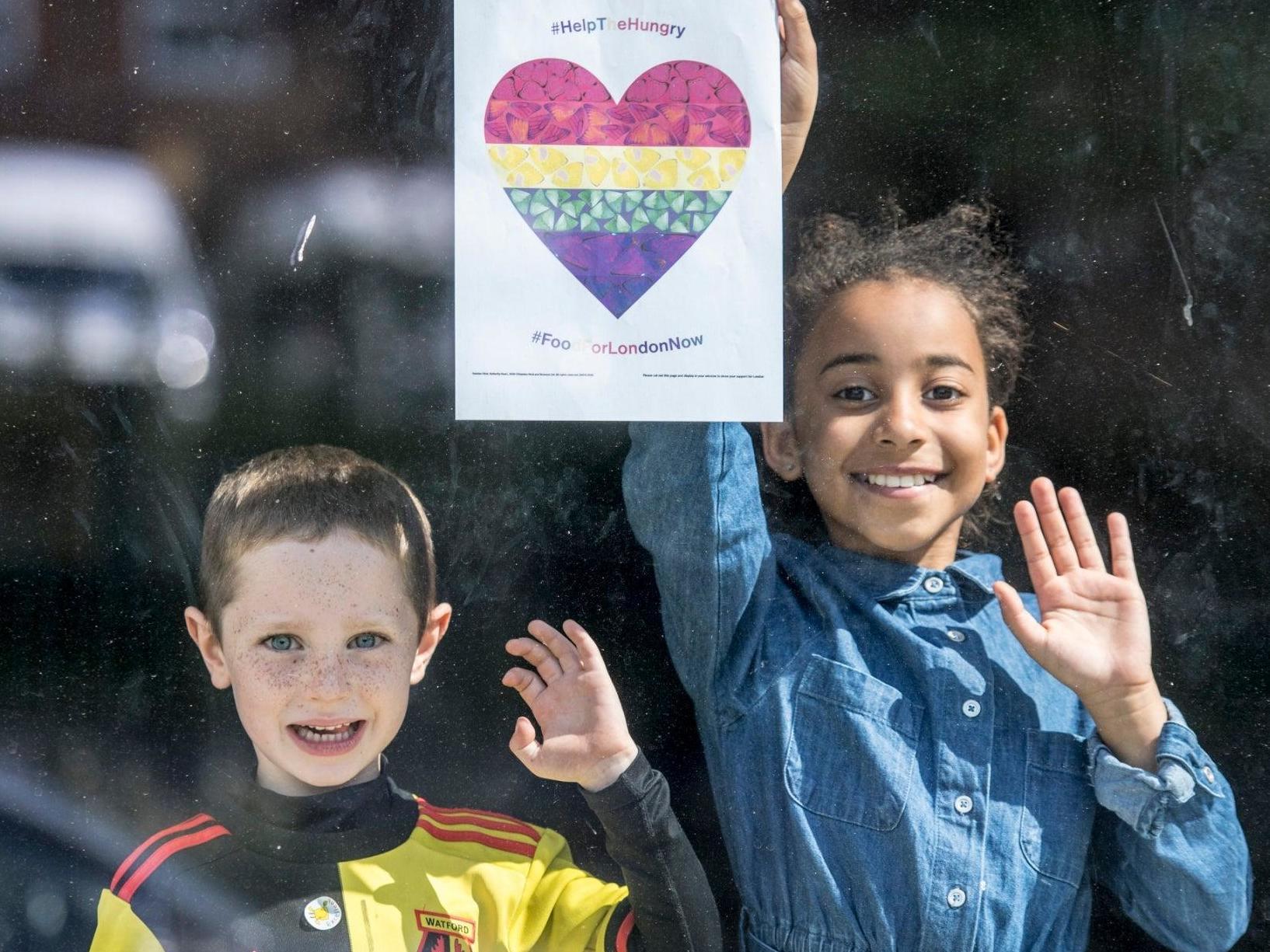 Aiden and Tanya from South Hill School in Hemel Hempstead put up Damien Hirst's butterfly heart in their school window