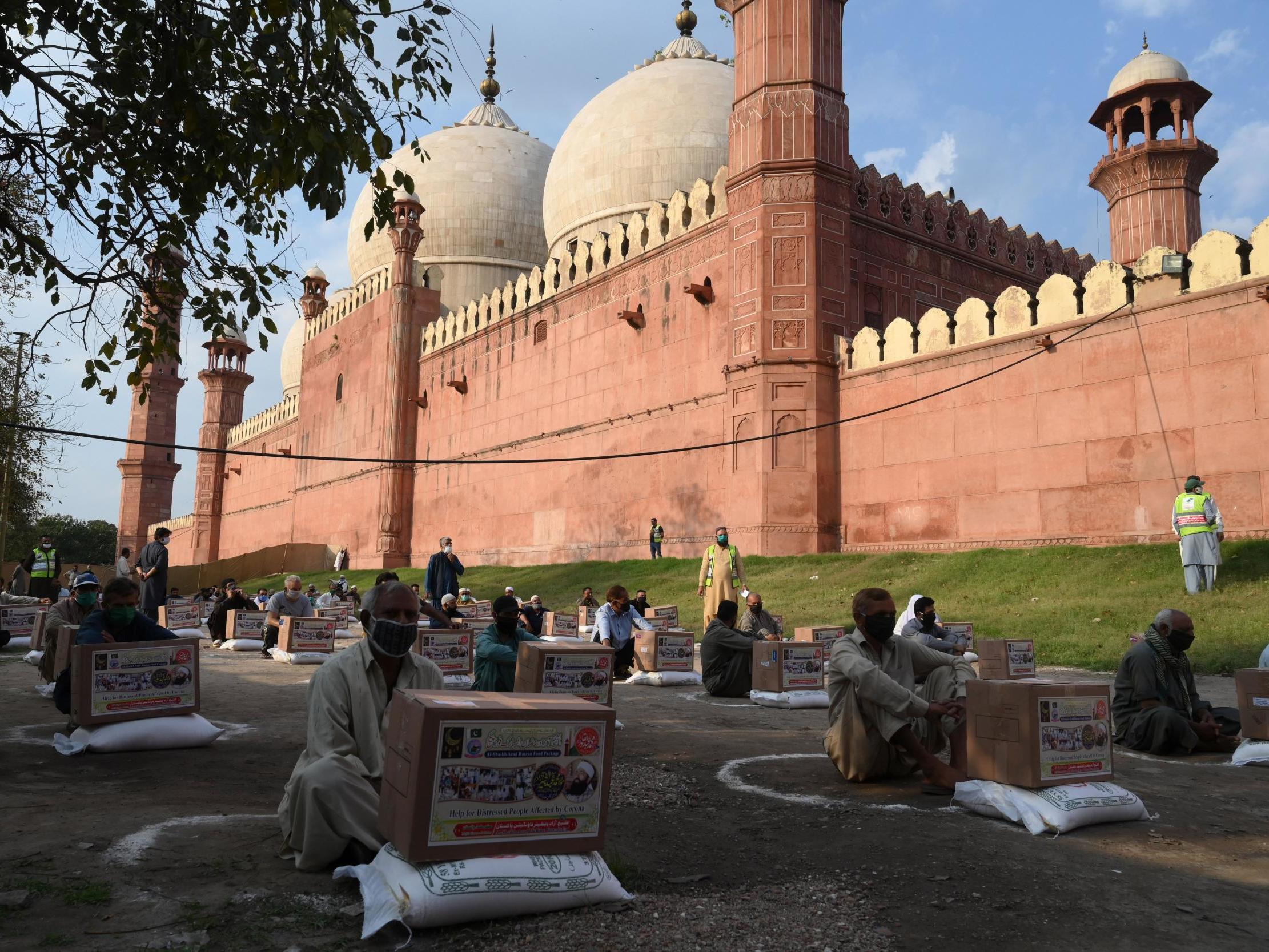 People outside the Badshahi mosque in Lahore