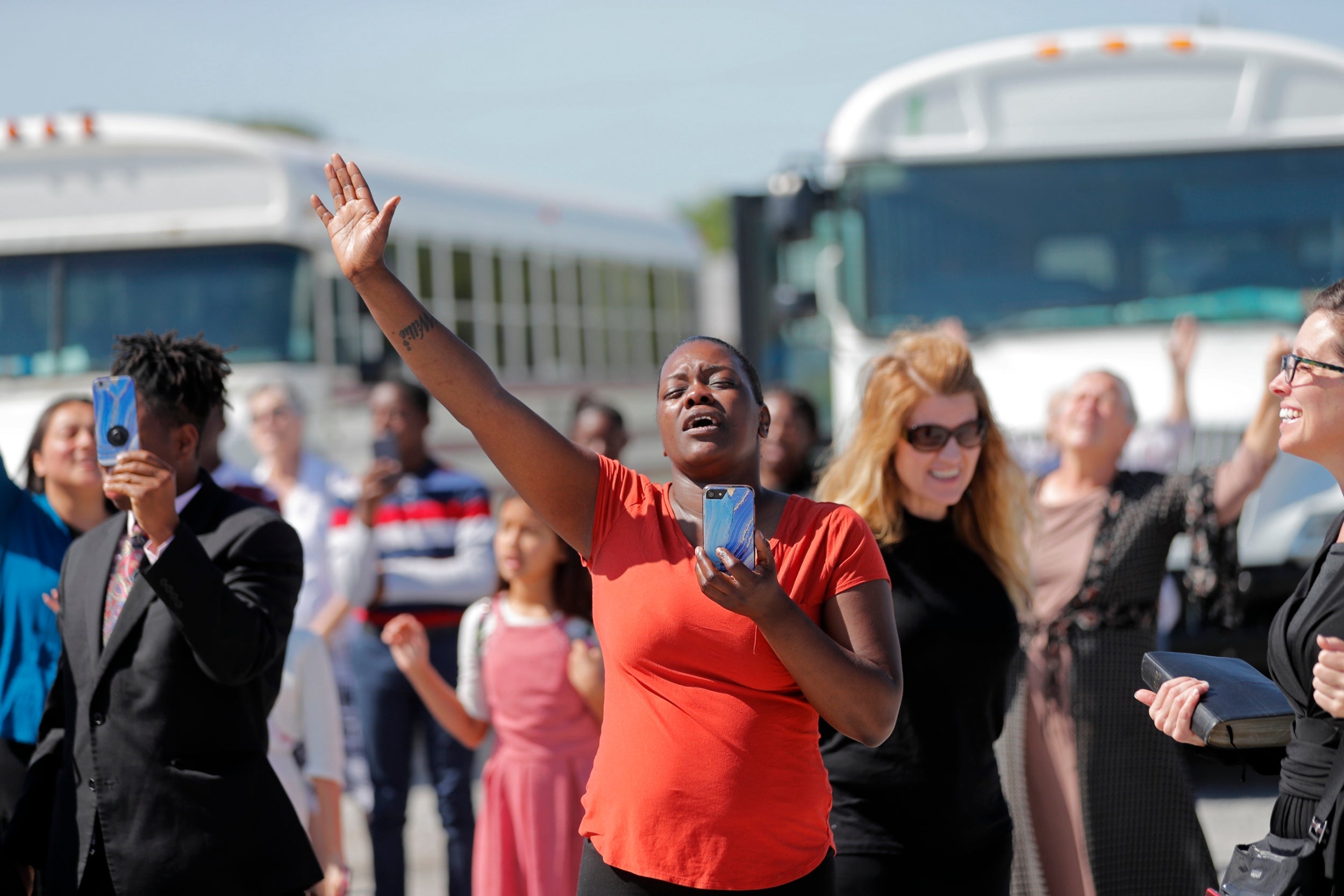 Members of the Life Tabernacle Church sing and pray as they wait for pastor Tony Spell to be released from prison in Baton Rouge following his arrest for flouting coronavirus lockdown orders