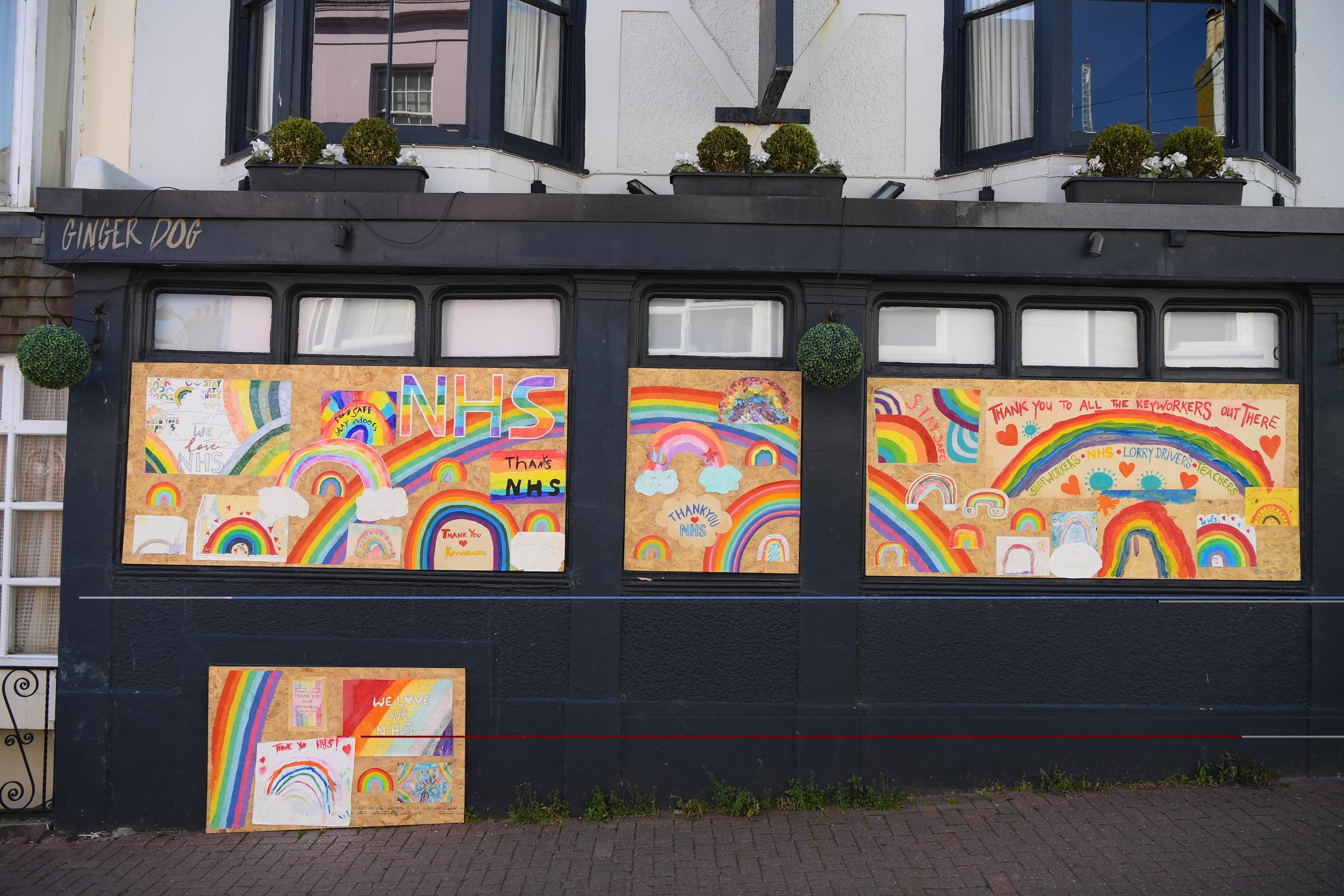 Brighton’s boarded up Ginger Dog pub is covered in supportive messages for the NHS