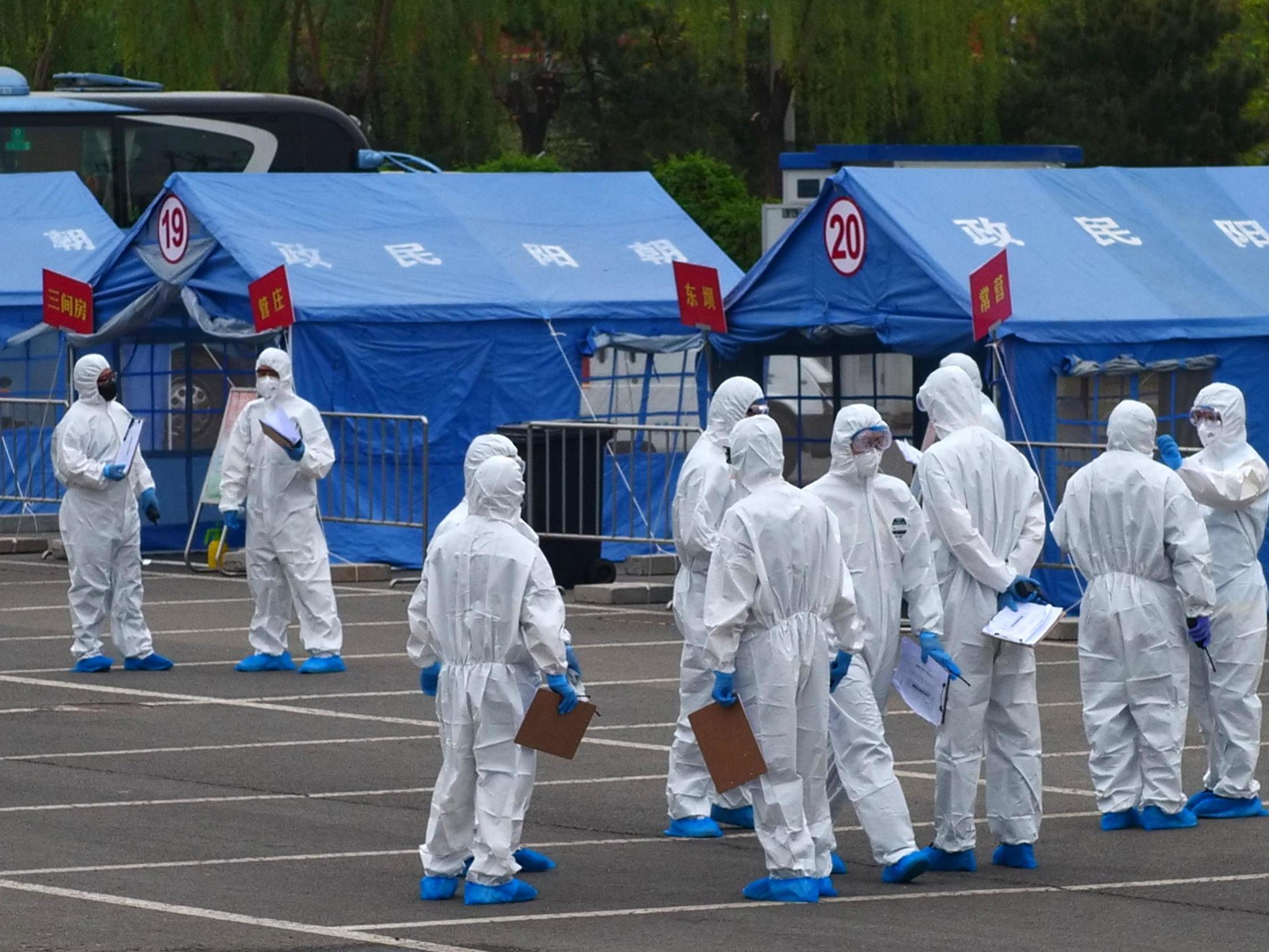 Government workers prepare to coordinate transportation of travellers from Wuhan to designated quarantine sites in Beijing on 15 April, 2020