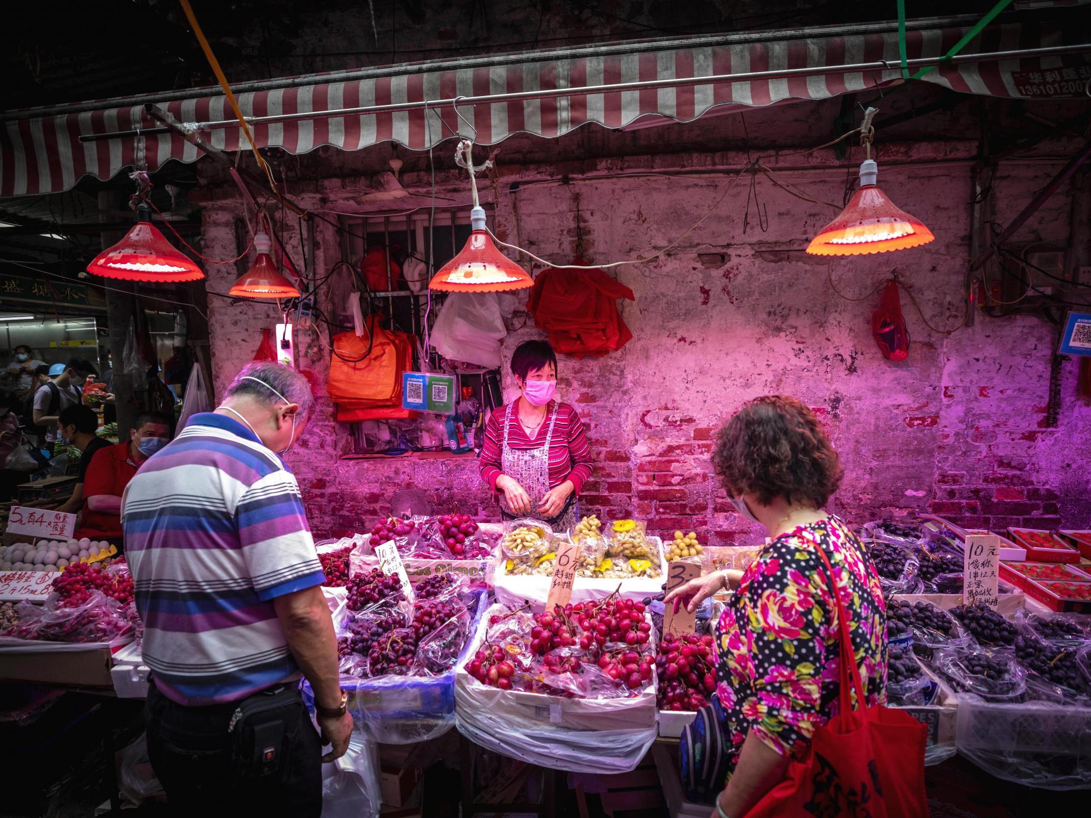 People buy meat at a wet market in Guangzhou, China