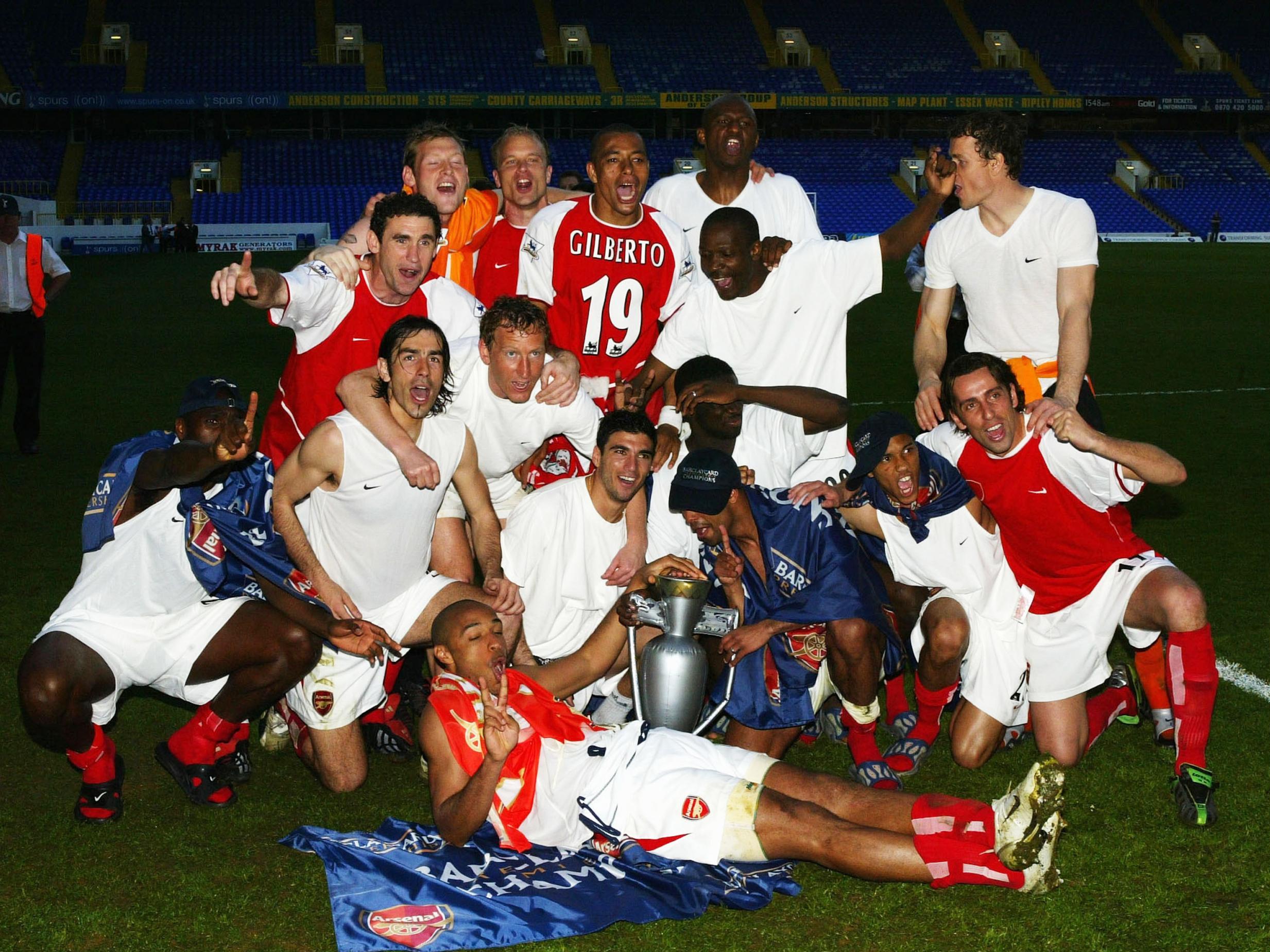 Arsenal celebrate on the pitch at White Hart Lane