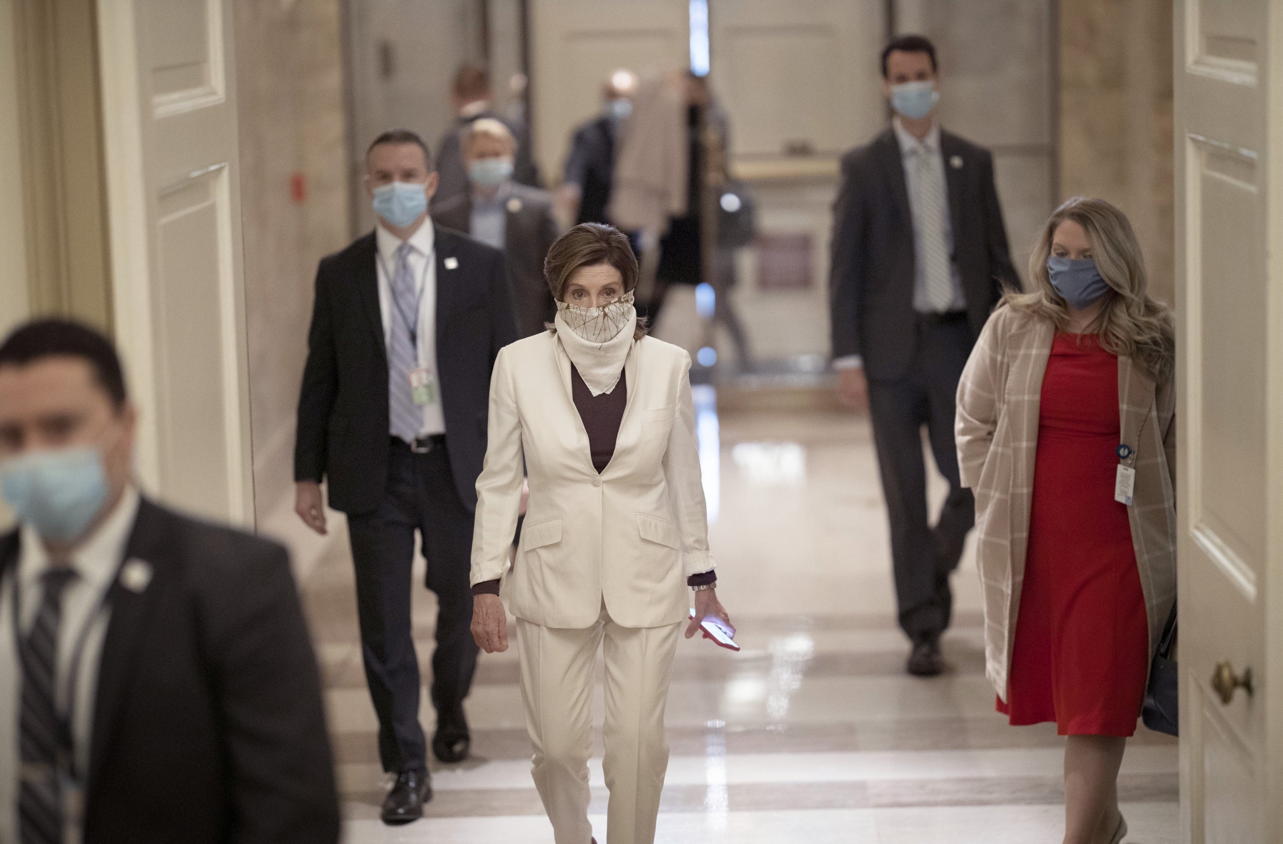 House Speaker Nancy Pelosi wears a face covering as she arrives at the US Capitol during the coronavirus pandemic