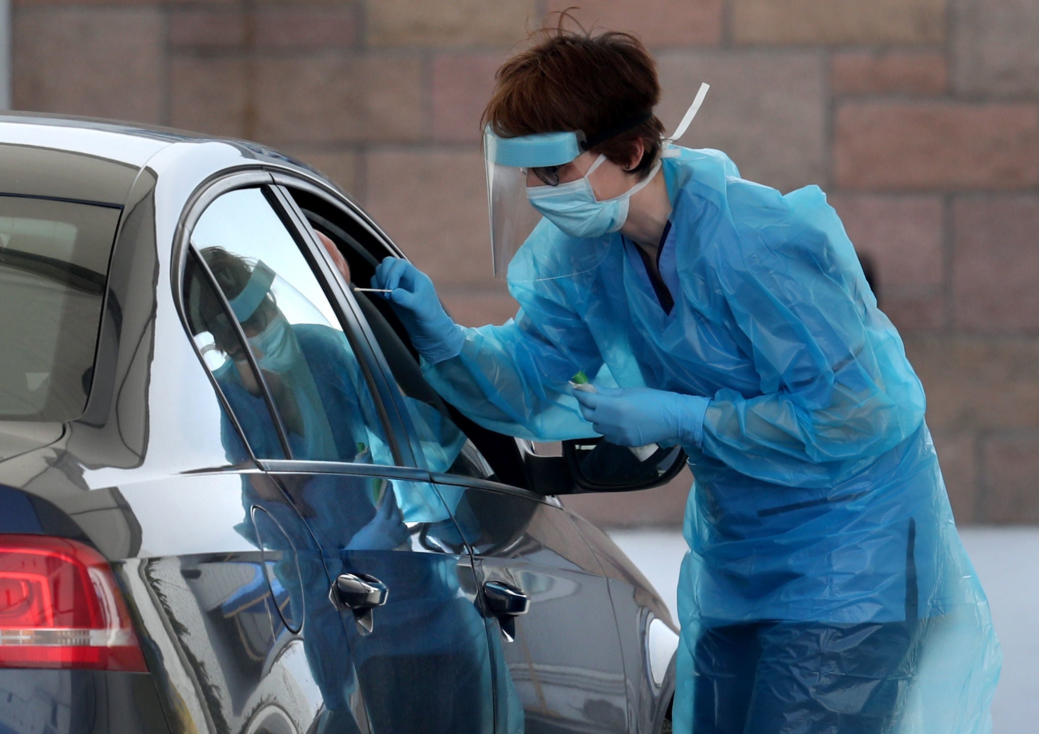 A nurse takes a sample at a COVID 19 testing centre in the car park of the Bowhouse Community Centre in Grangemouth as the UK continues in lockdown to help curb the spread of the coronavirus