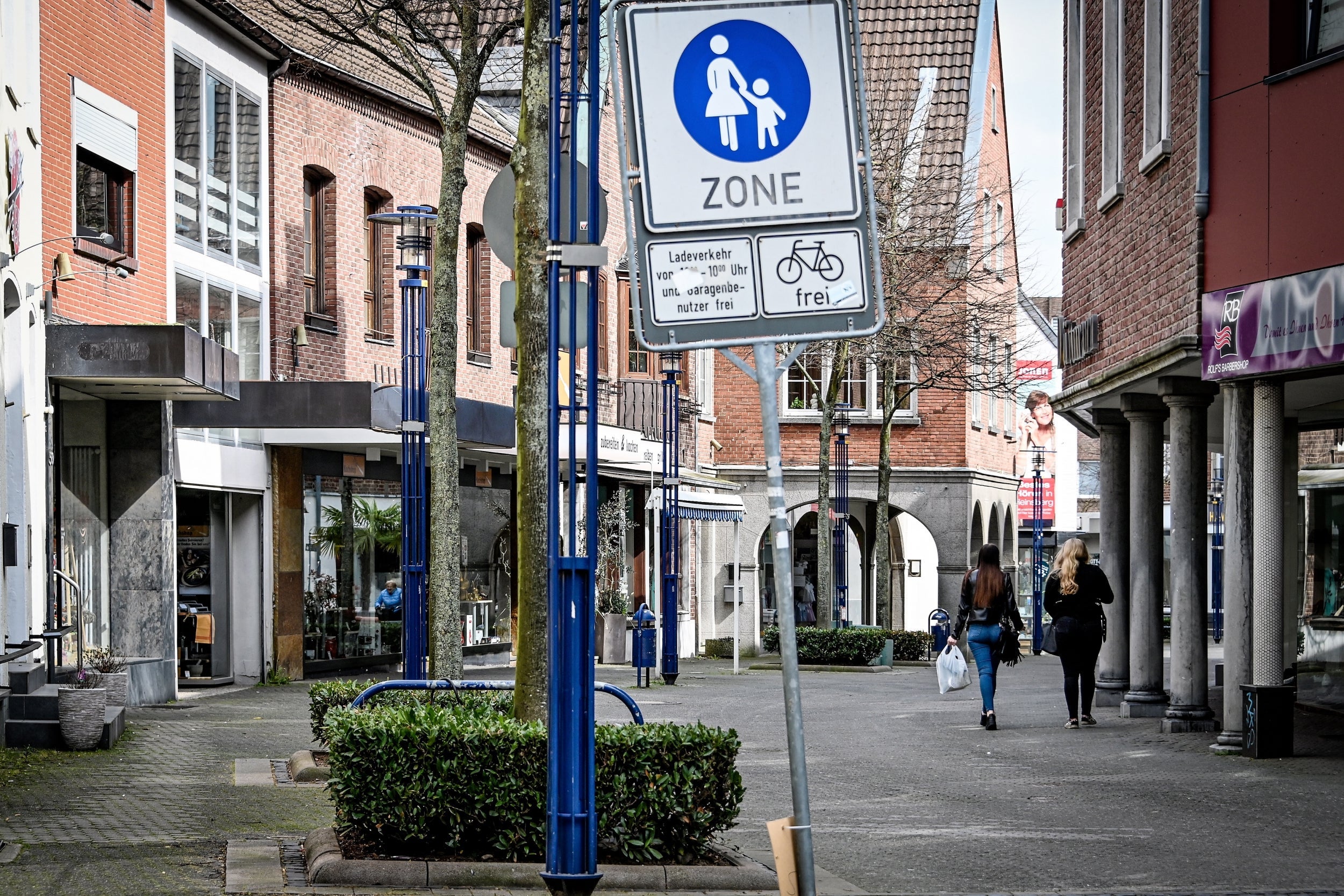 People walk through the lonesome pedestrian zone in Heinsberg