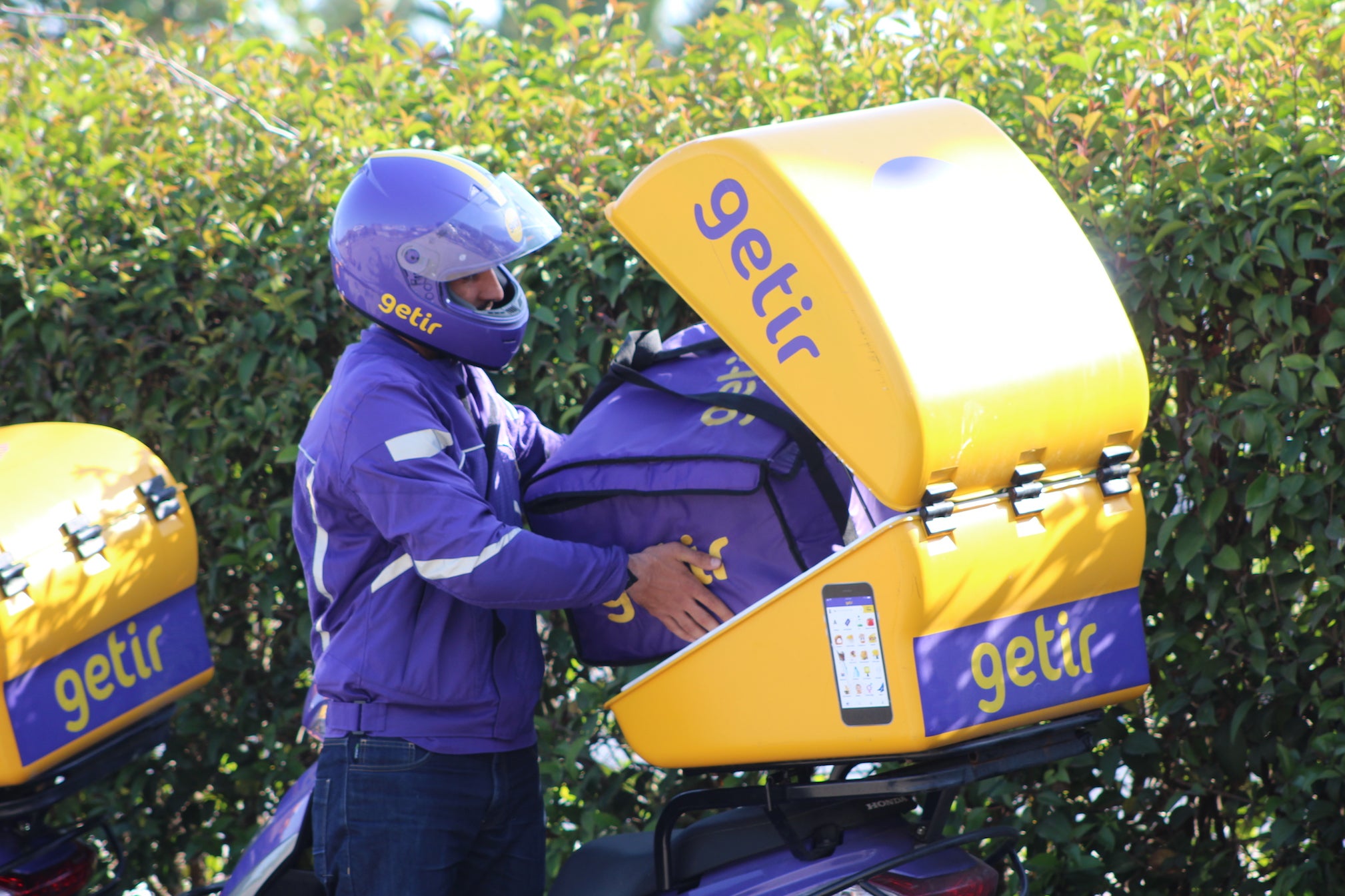 A Getir worker loads up groceries for a delivery in Turkey