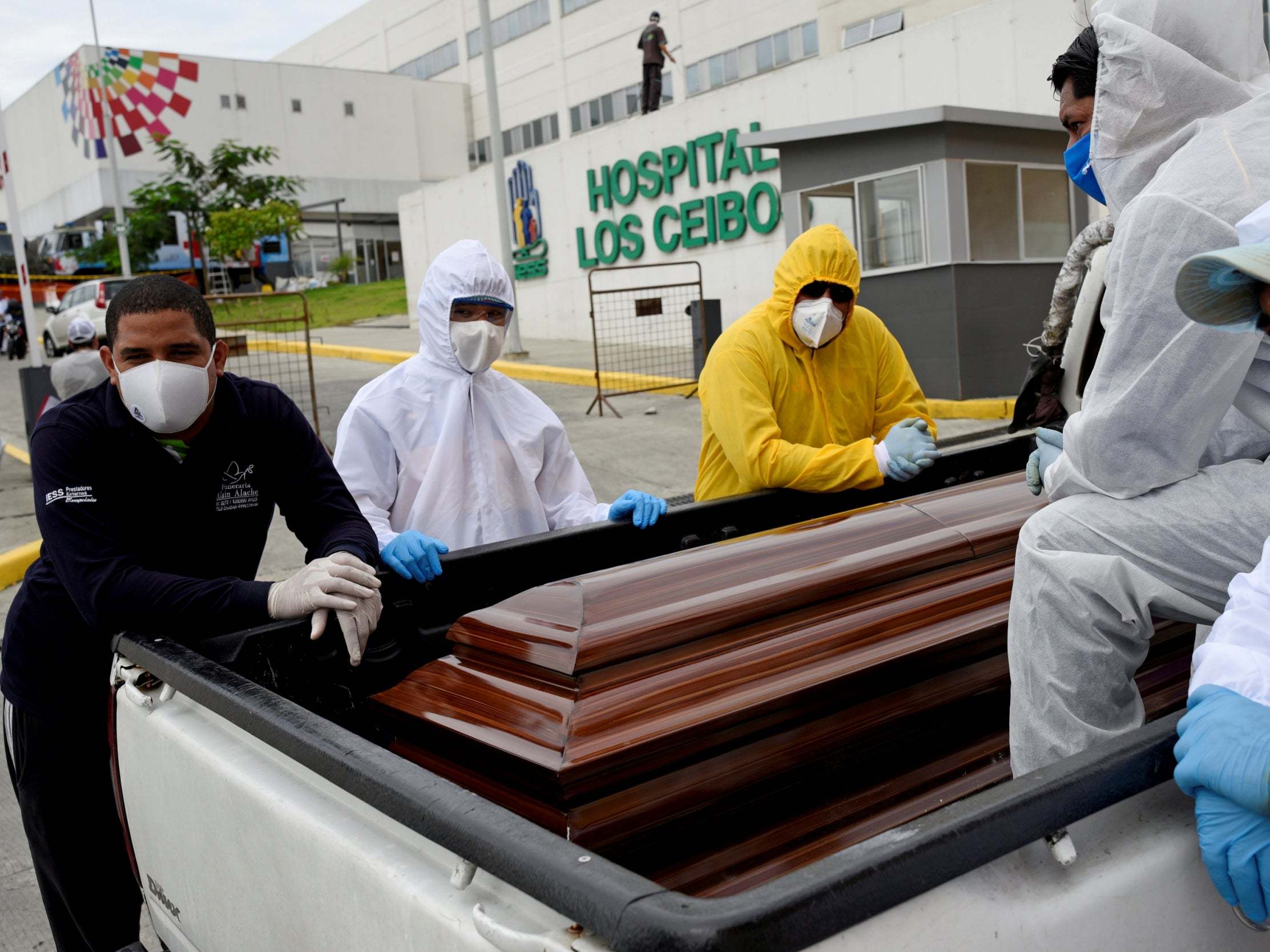 Funeral workers use a pick-up truck in Guayaquil, Equador, as the country struggles