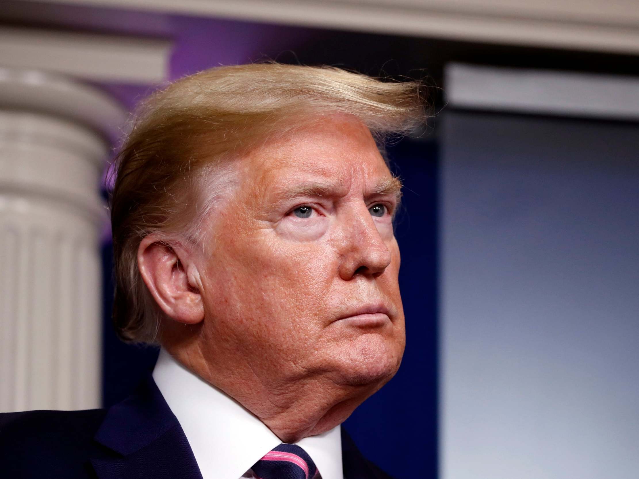 President Donald Trump listens during a briefing about the coronavirus at the White House in Washington