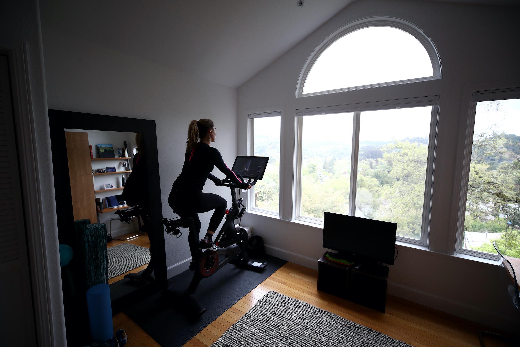 Cari Gundee rides her Peloton exercise bike at her home on April 06, 2020 in San Anselmo, California. More people are turning to Peloton due to shelter-in-place orders because of the coronavirus (COVID-19). Peloton stock has continued to rise over recent weeks even as most of the stock market has plummeted