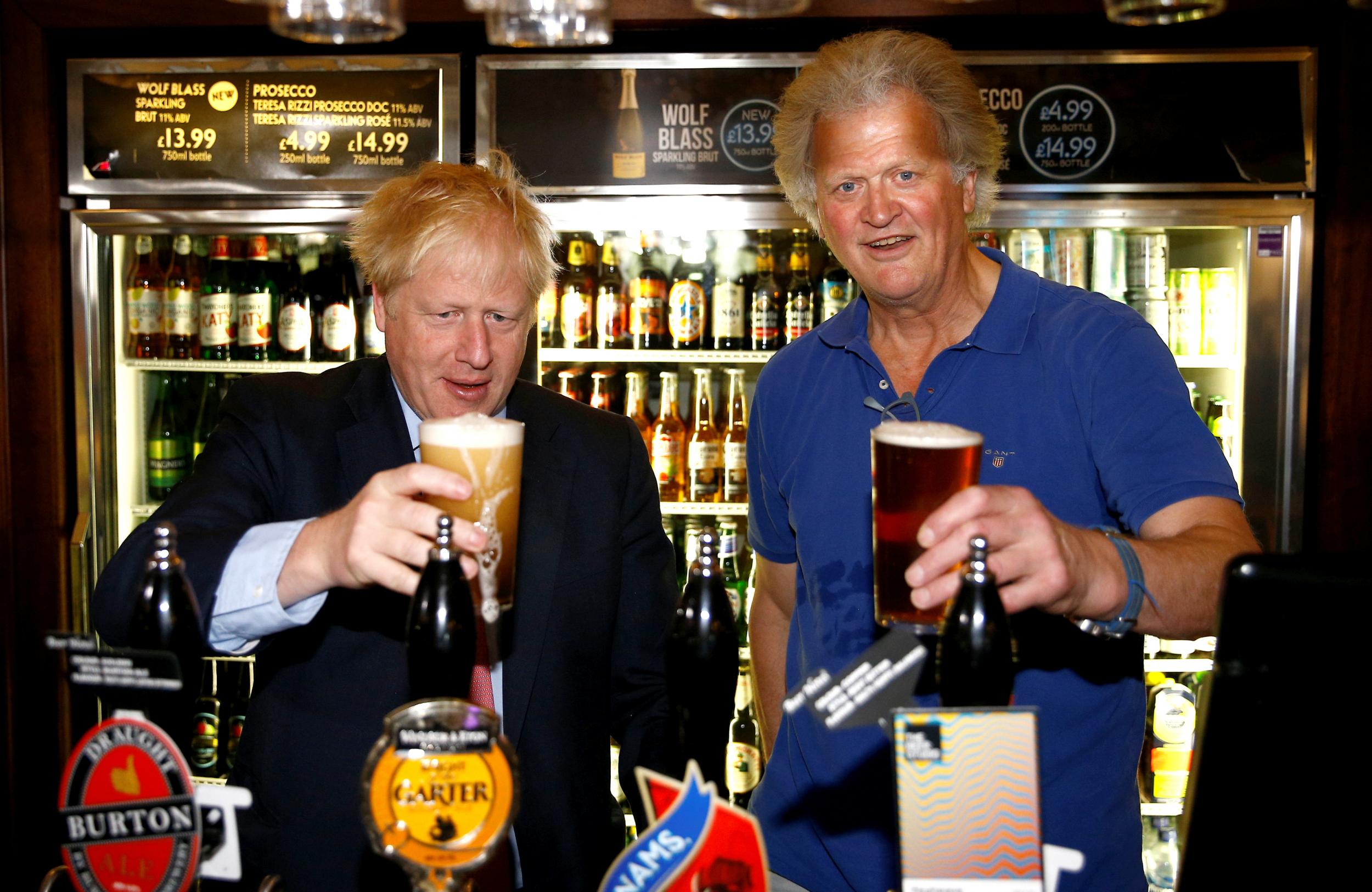 Boris Johnson pulls a pint as he meets with JD Wetherspoon chairman, Tim Martin