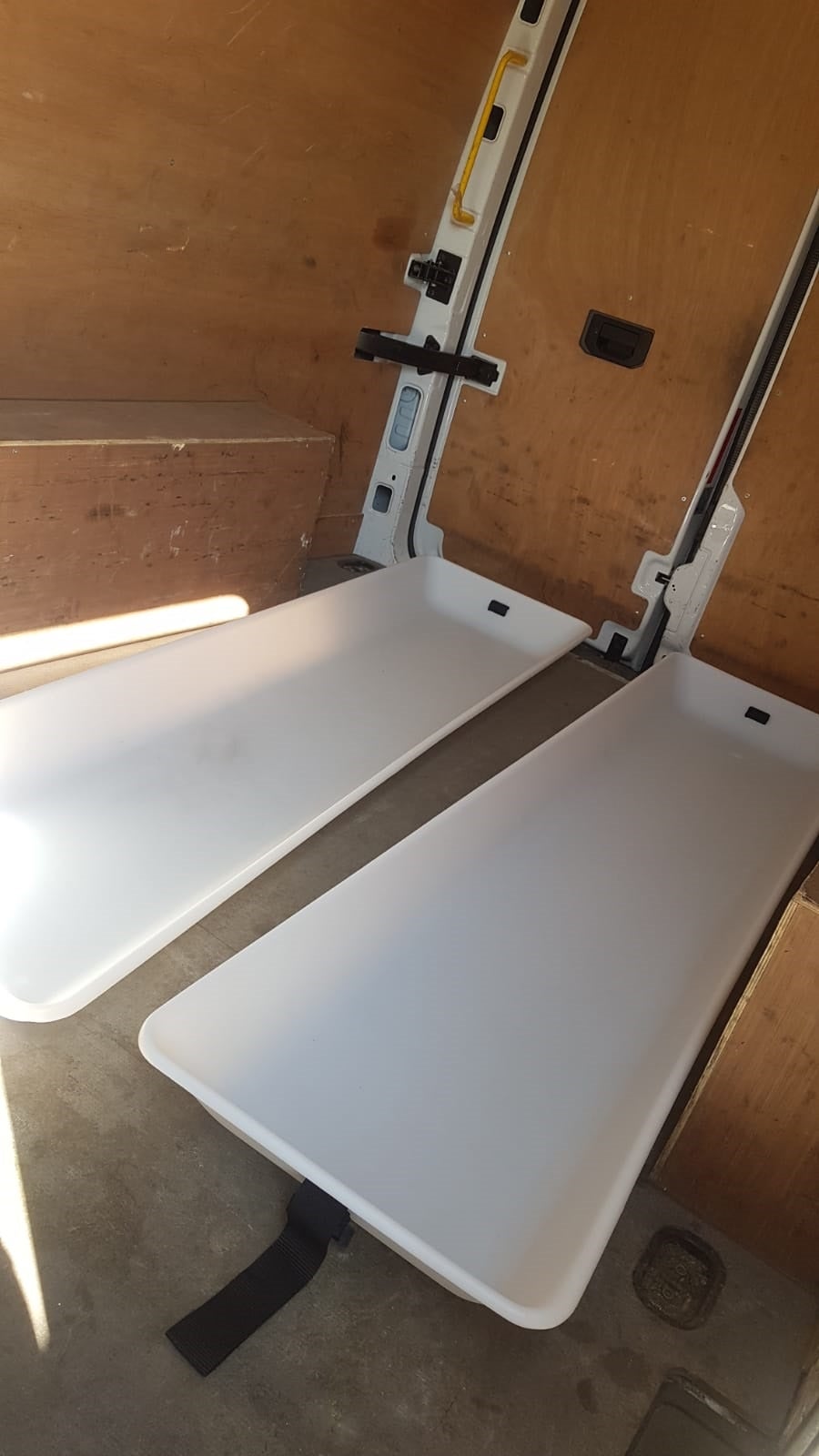 White plastic trays inside van