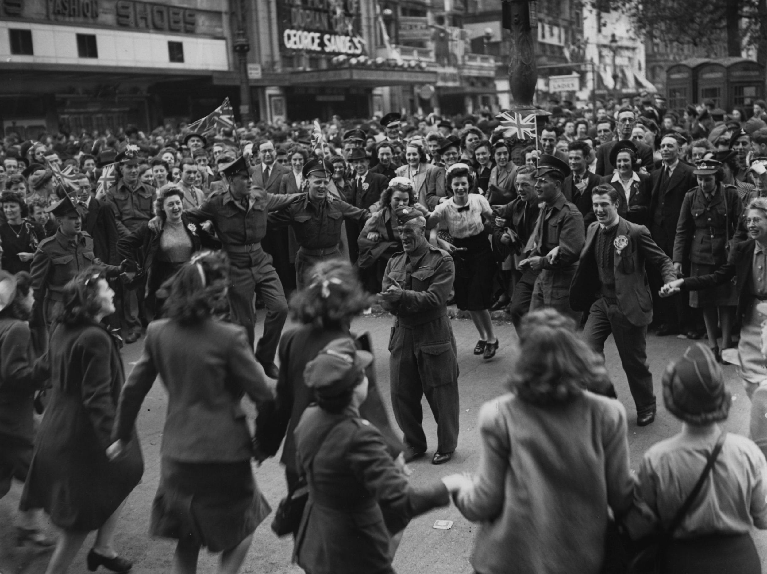 Canadian troops entertain the crowds in Leicester Square while waiting for the broadcast of the King’s VE Day speech