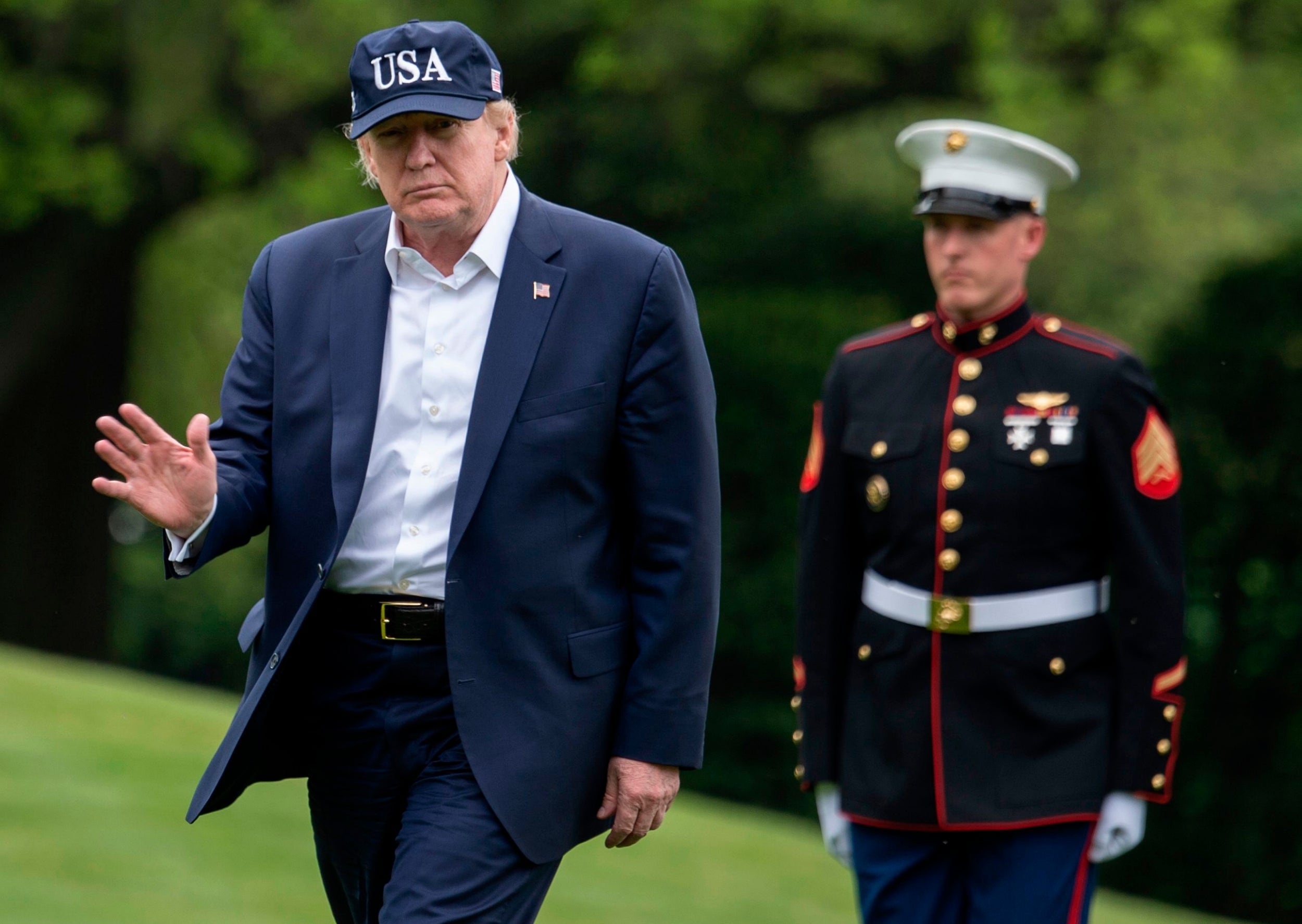 &#13;
President Donald Trump waves as he walks from Marine One at the White House on 3 May (Photo by ANDREW CABALLERO-REYNOLDS/AFP via Getty Images) &#13;