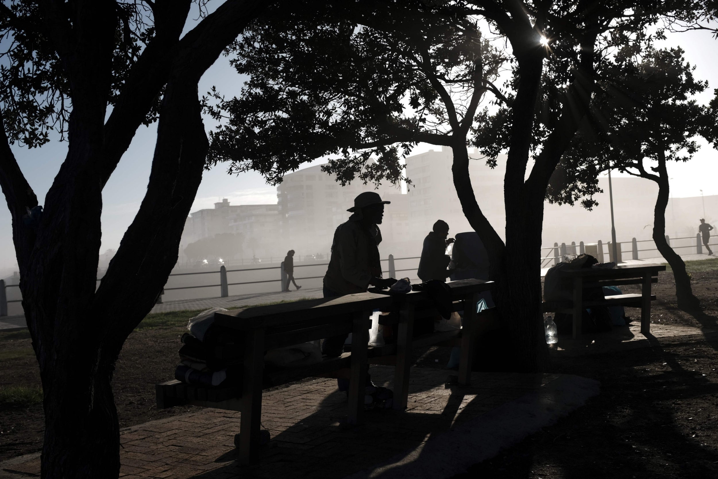 Homeless people tend to their belongings in Cape Town, where South Africa is slowly easing out of lockdown