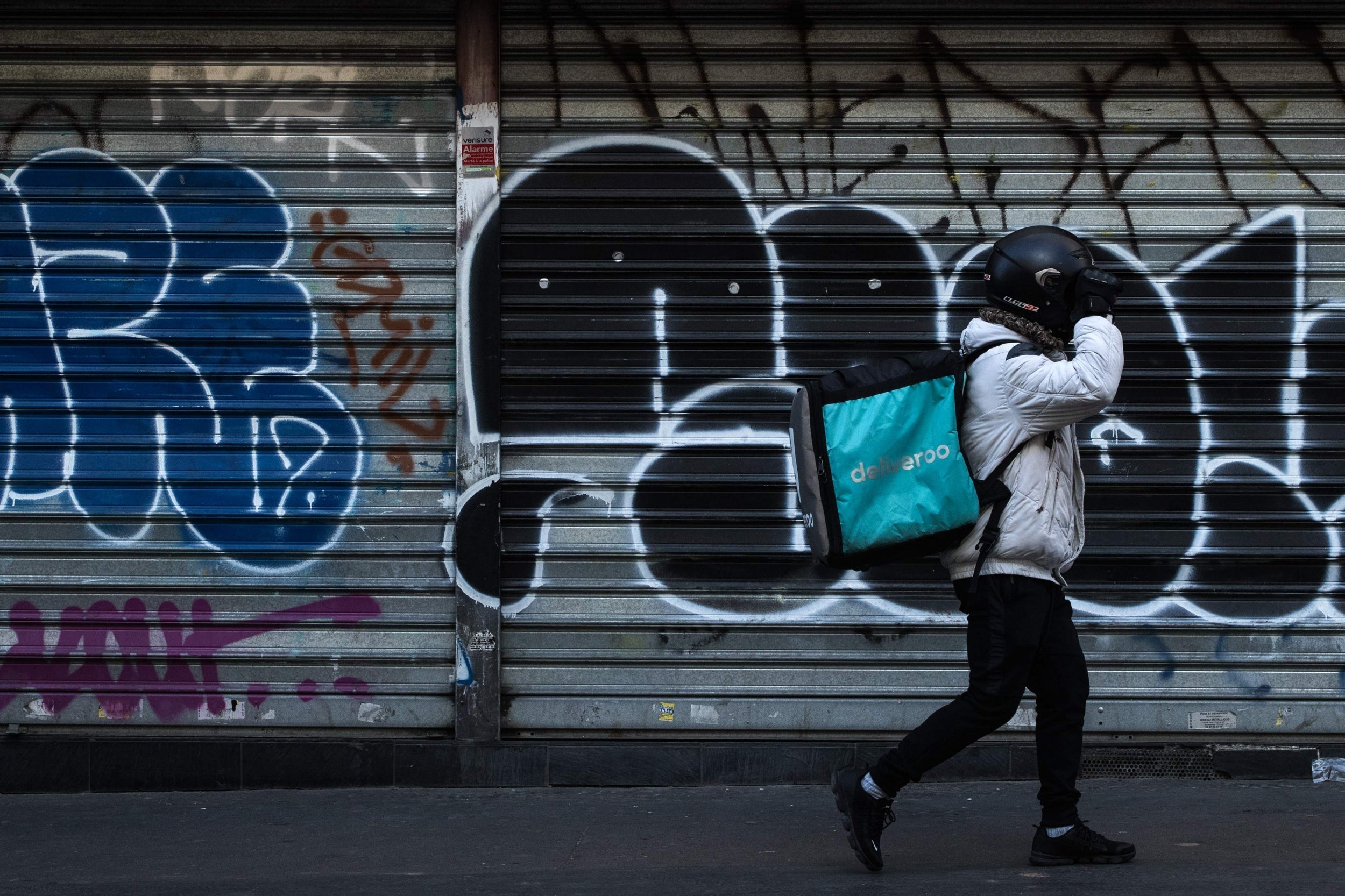 A man working for food delivery service Deliveroo walks in Paris during lockdown (AFP/Getty)
