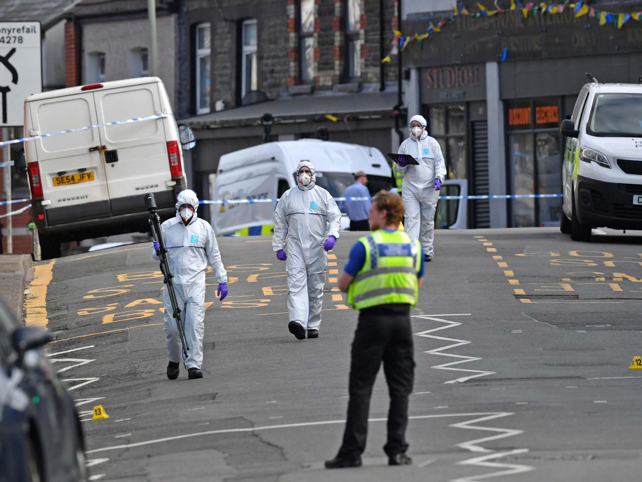 Forensic officers at the scene in Pen Y Graig in South Wales.