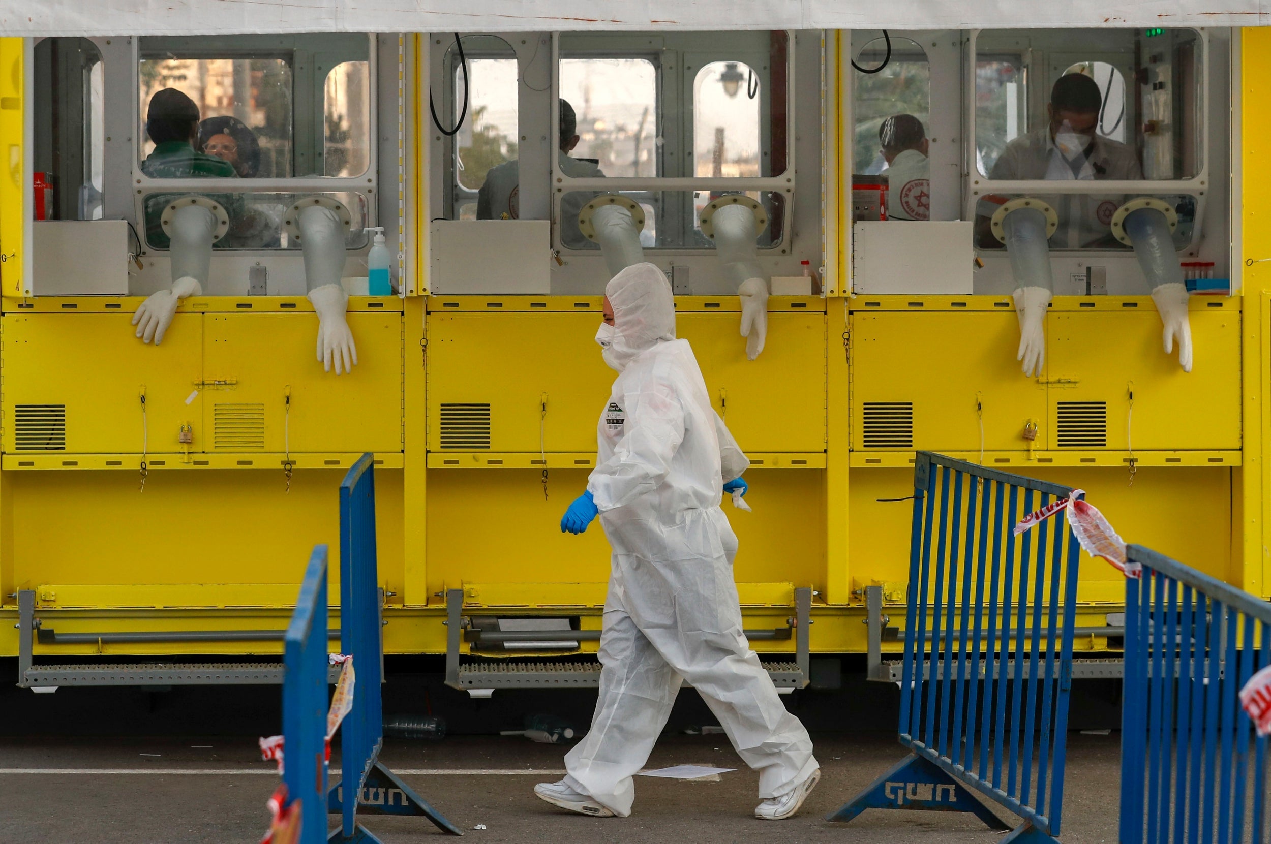 A paramedic walks beside a Covid-19 mobile testing station in the Geula neighbourhood in Jerusalem