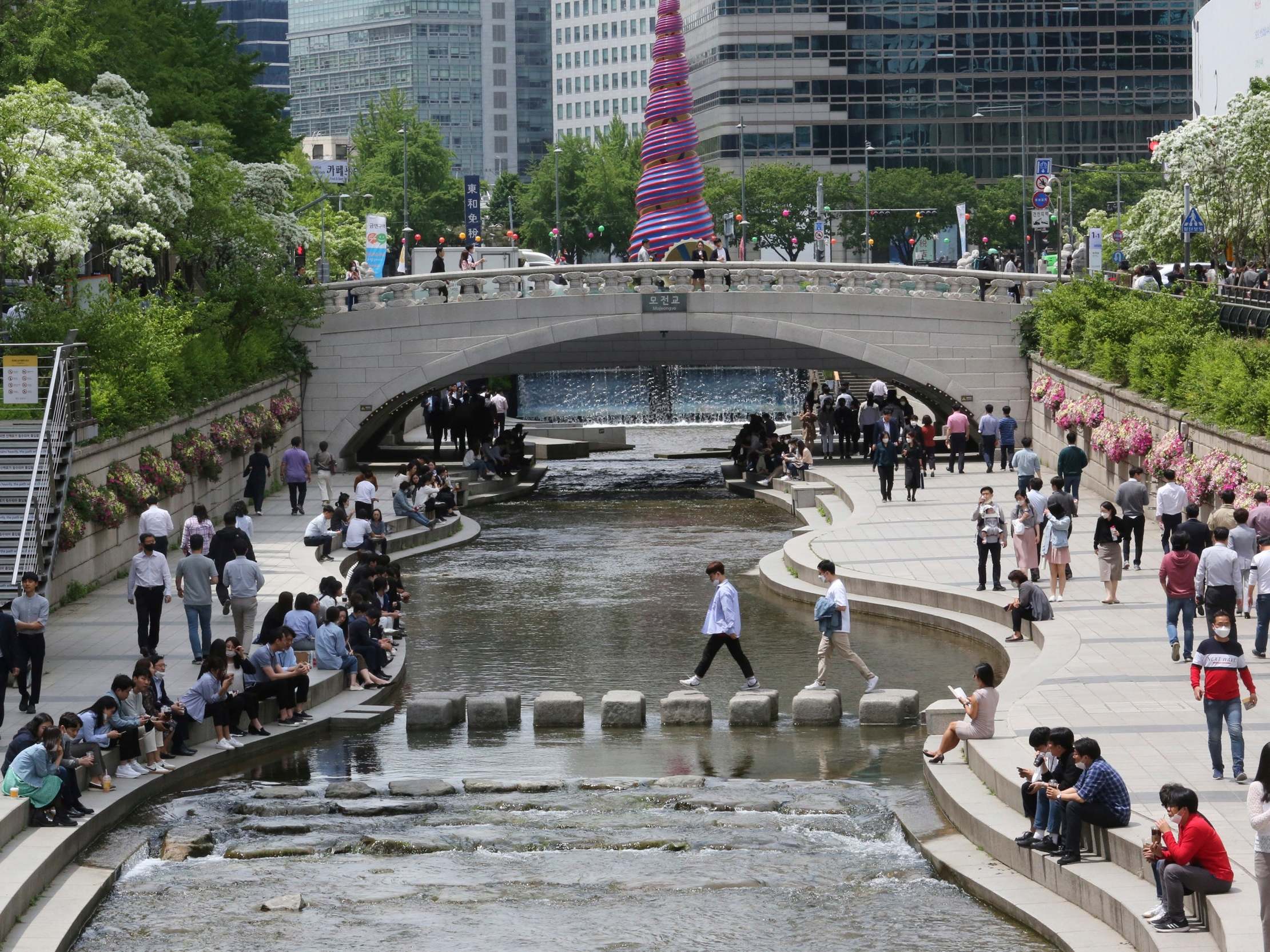 People relax this week as daily life in Seoul is slowly returning to normal amid a lifting of restrictions in South Korea