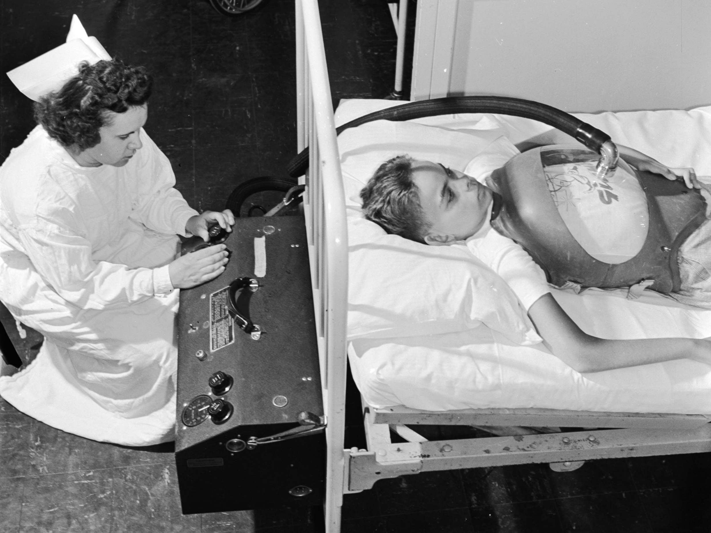 A boy suffering from polio being is treated with an ‘iron lung’ in hospital