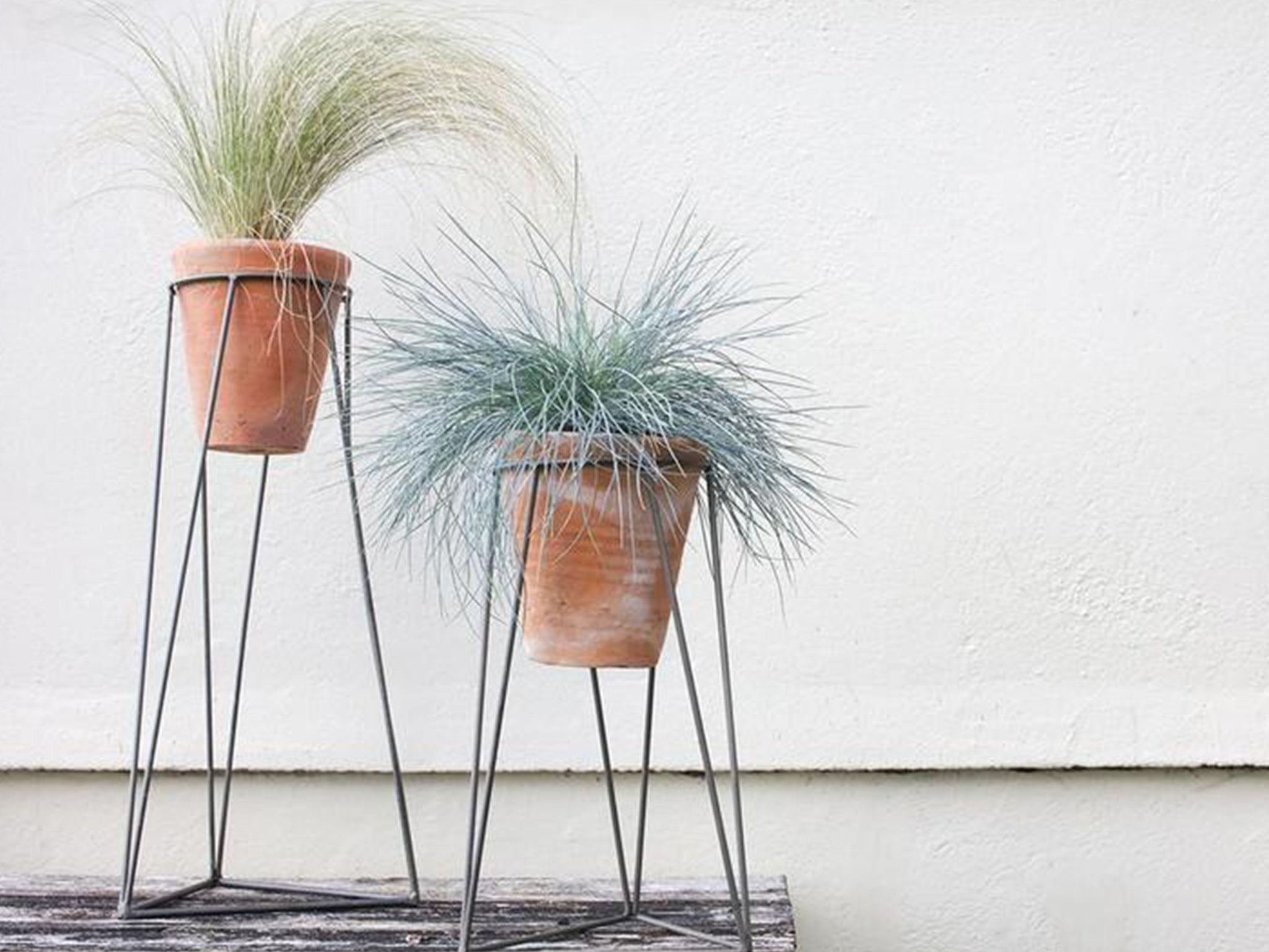 A chic plant stand will not only keep your patio space tidy but allow you to bring big plants into your garden without them taking up as much room