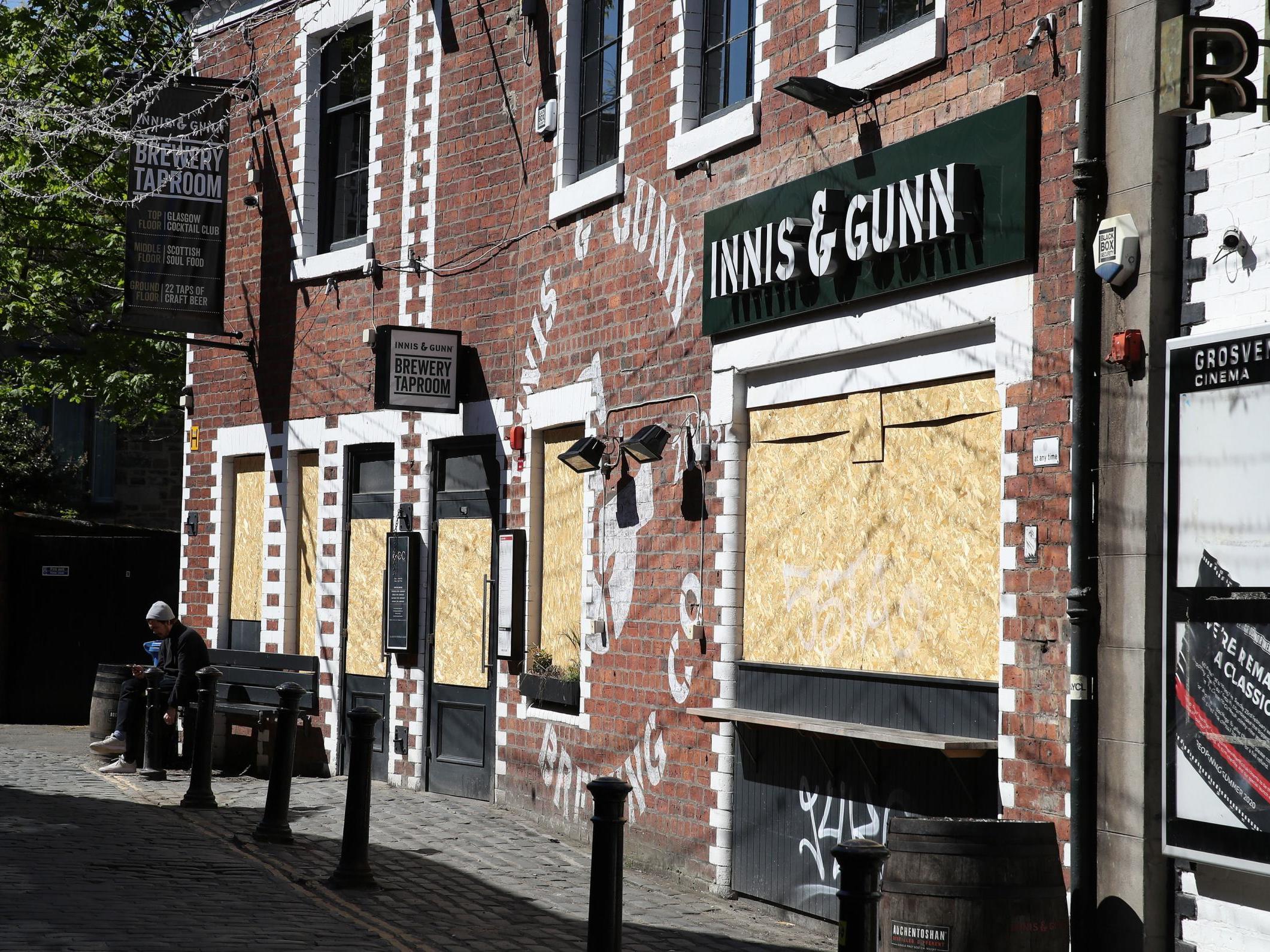 A view of boarded up restaurants and pubs in Ashton Lane in Glasgow as the UK continues in lockdown to help curb the spread of the coronavirus