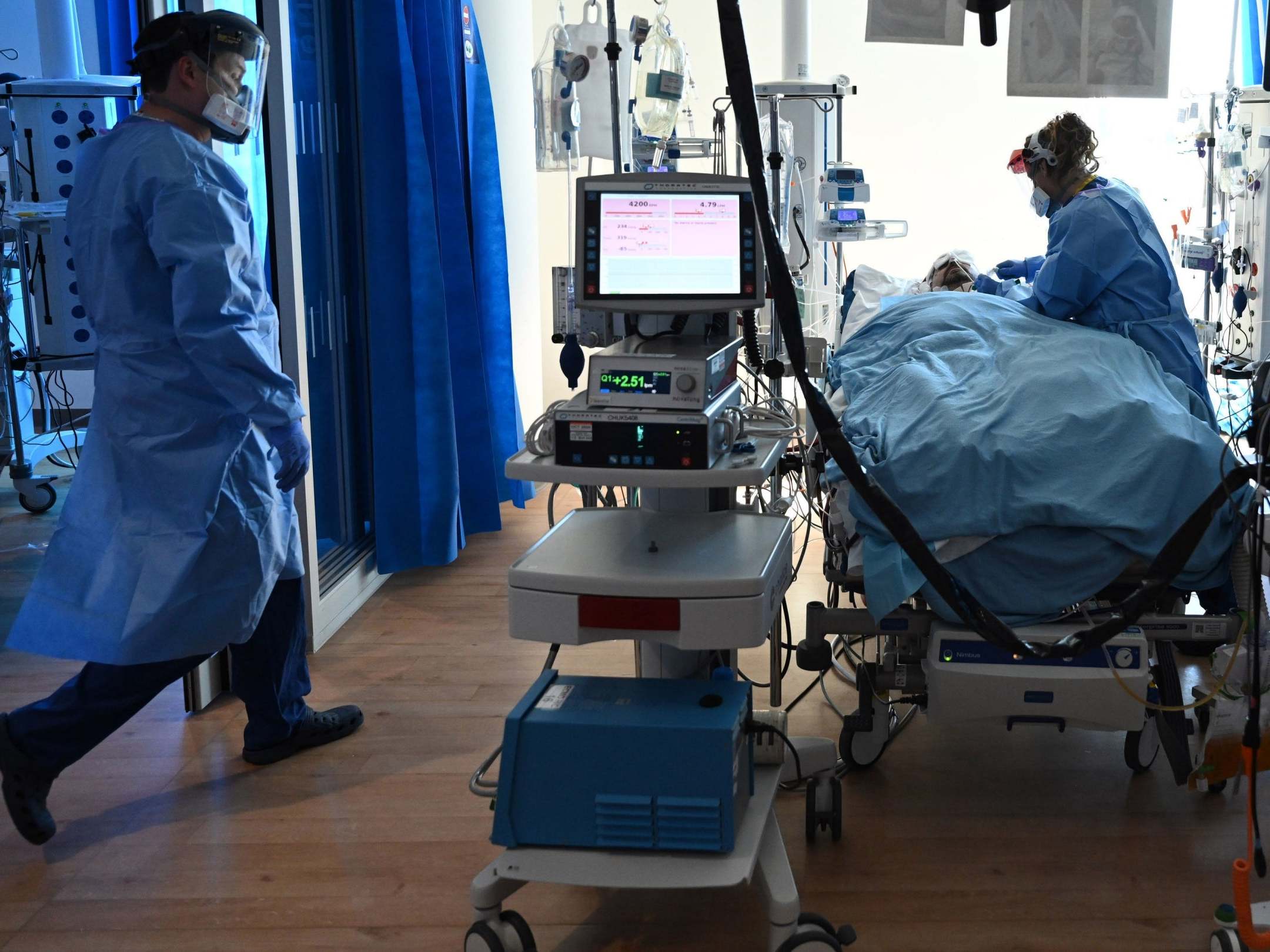 Clinical staff wear personal protective equipment (PPE) as they care for a patient at the intensive care unit at the Royal Papworth Hospital in Cambridge, 5 May 2020.