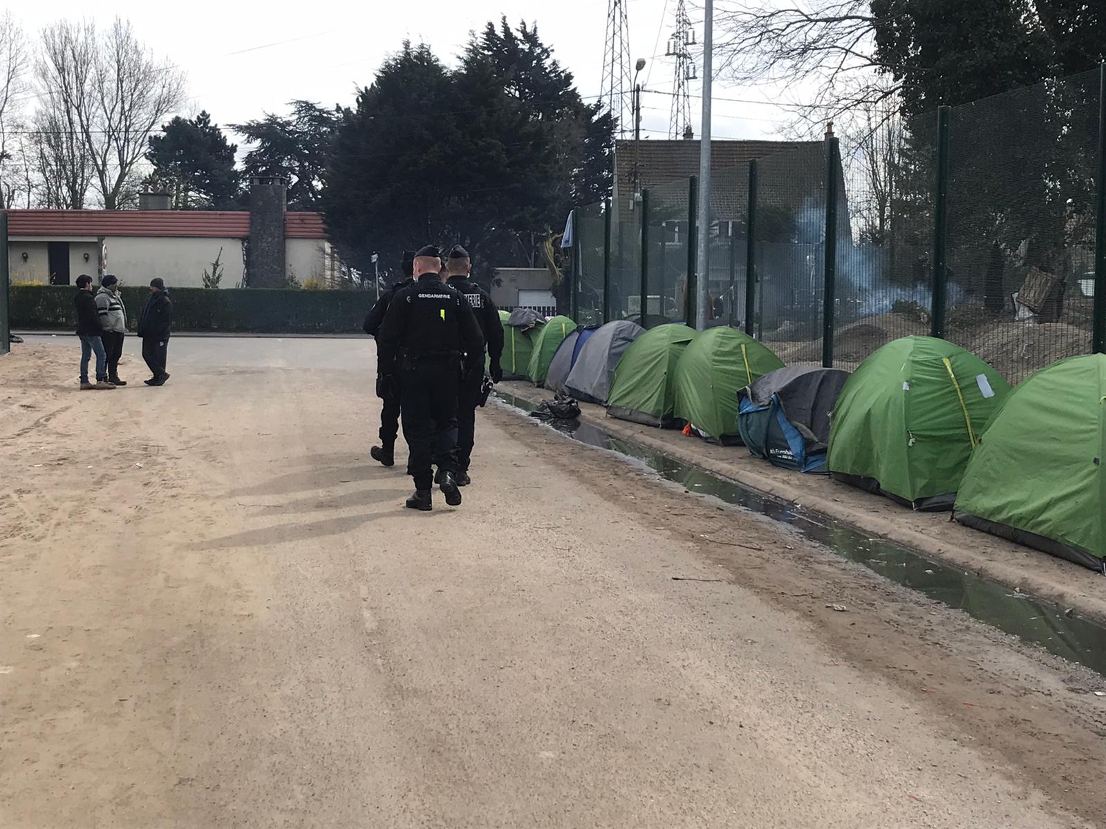 Tents lined up by a fence in Calais