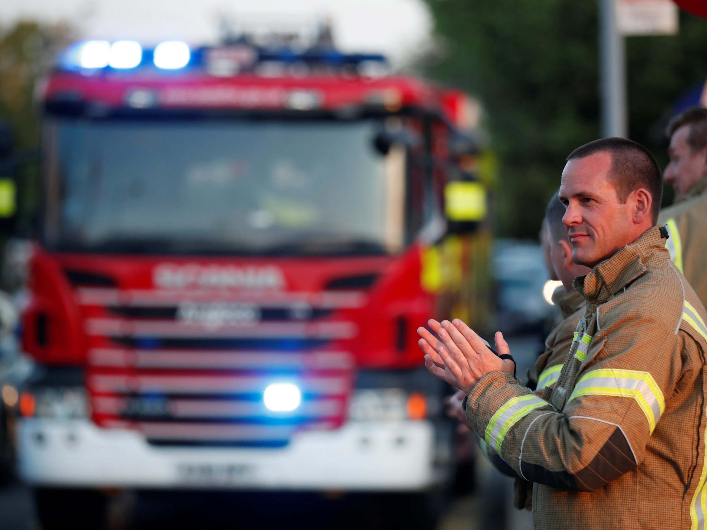 Firefighters react at Luton and Dunstable University Hospital during the Clap for our Carers event in support of the NHS in Luton on 7 May