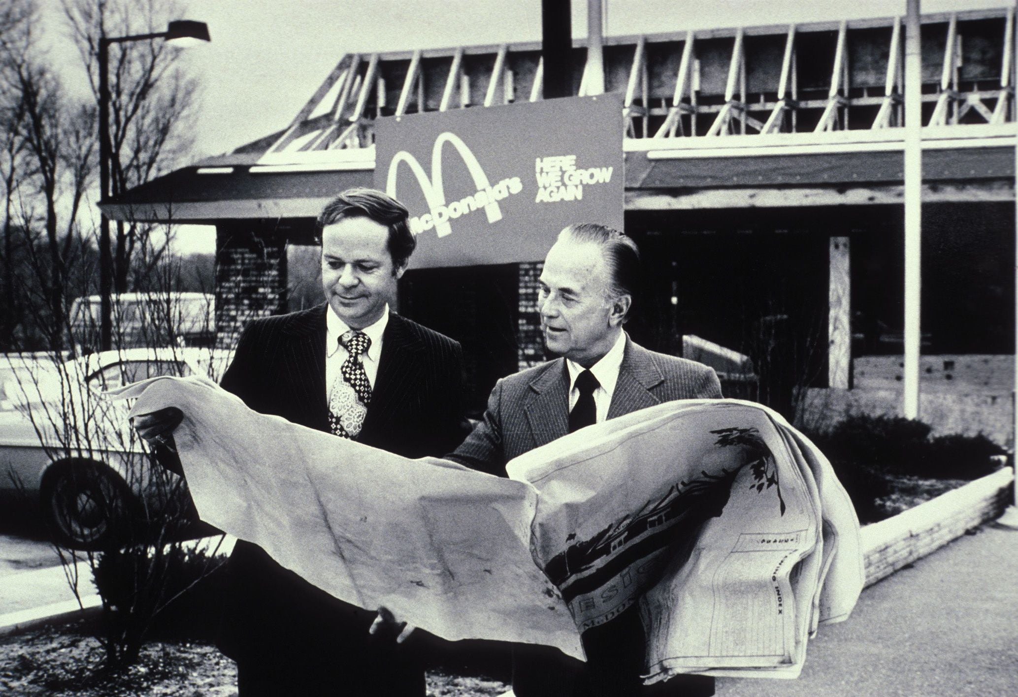 Fred Turner and Ray Kroc the executive leaders of McDonalds Corporation looking at blueprints of future restaurant (photo ca. 1975)