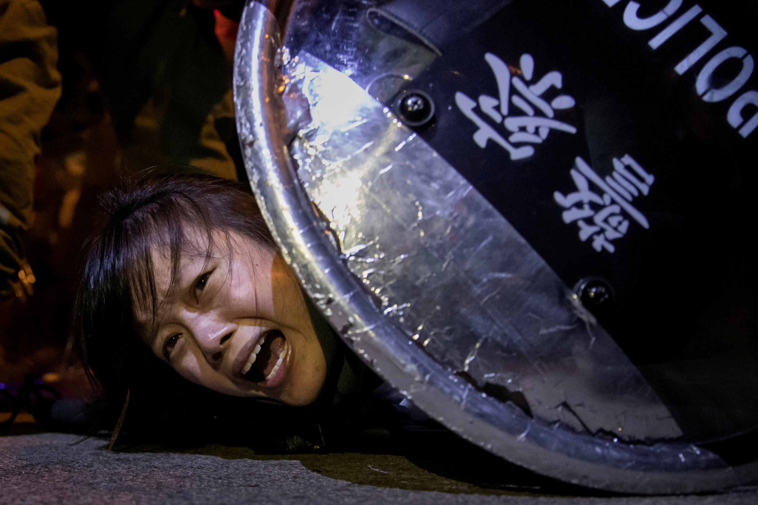 An anti-extradition bill protester is detained by riot police during skirmishes between the police and protesters outside Mong Kok police station, 2 September, 2019
