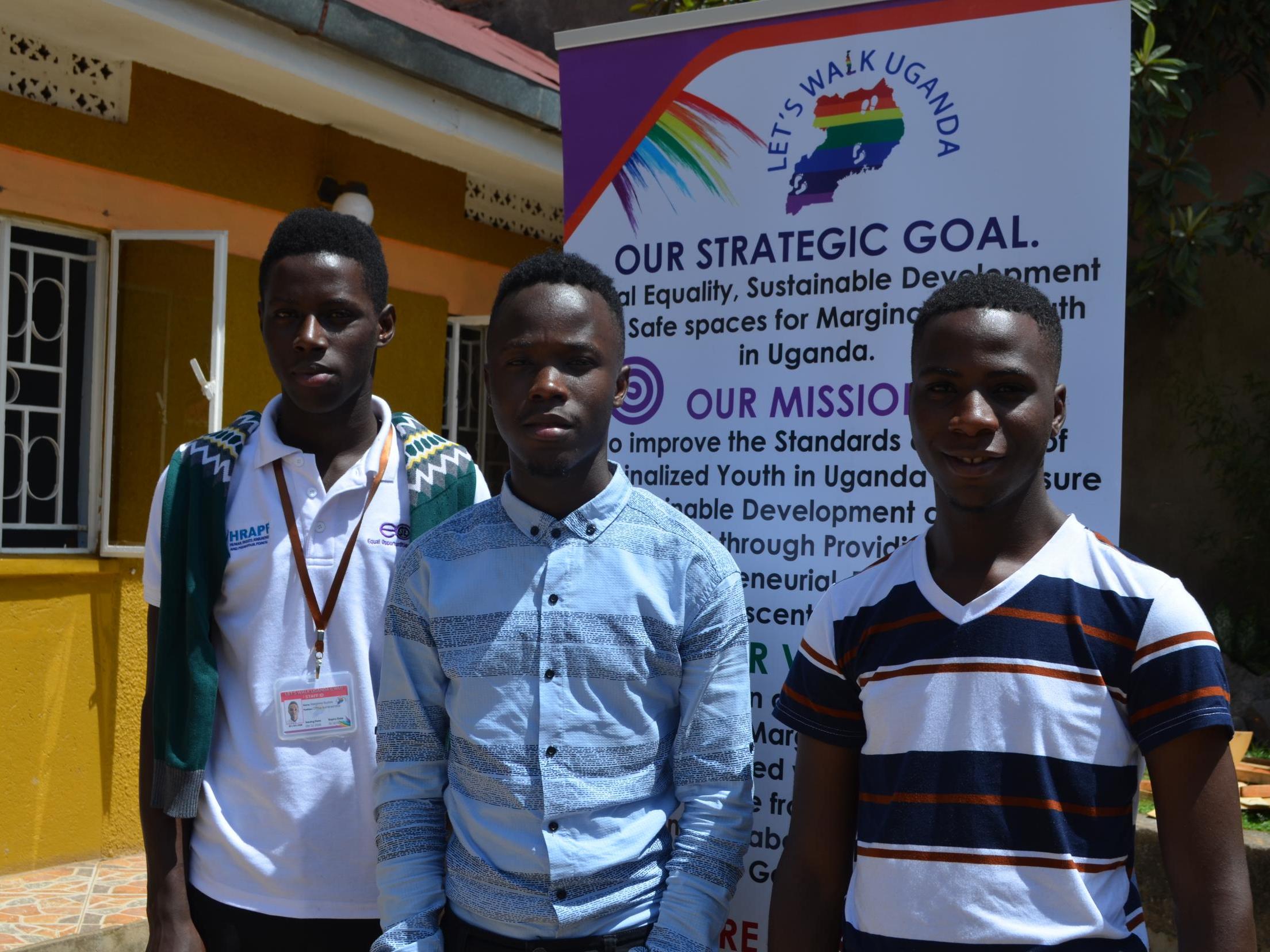 Let’s Walk Uganda volunteers Sudais Ssegawa Kapool, 22, Hakim Lukwago, 19, and Eric Ndawula, 23, stand outside the charity’s new offices in Kampala (Portia Crowe/The Independent)