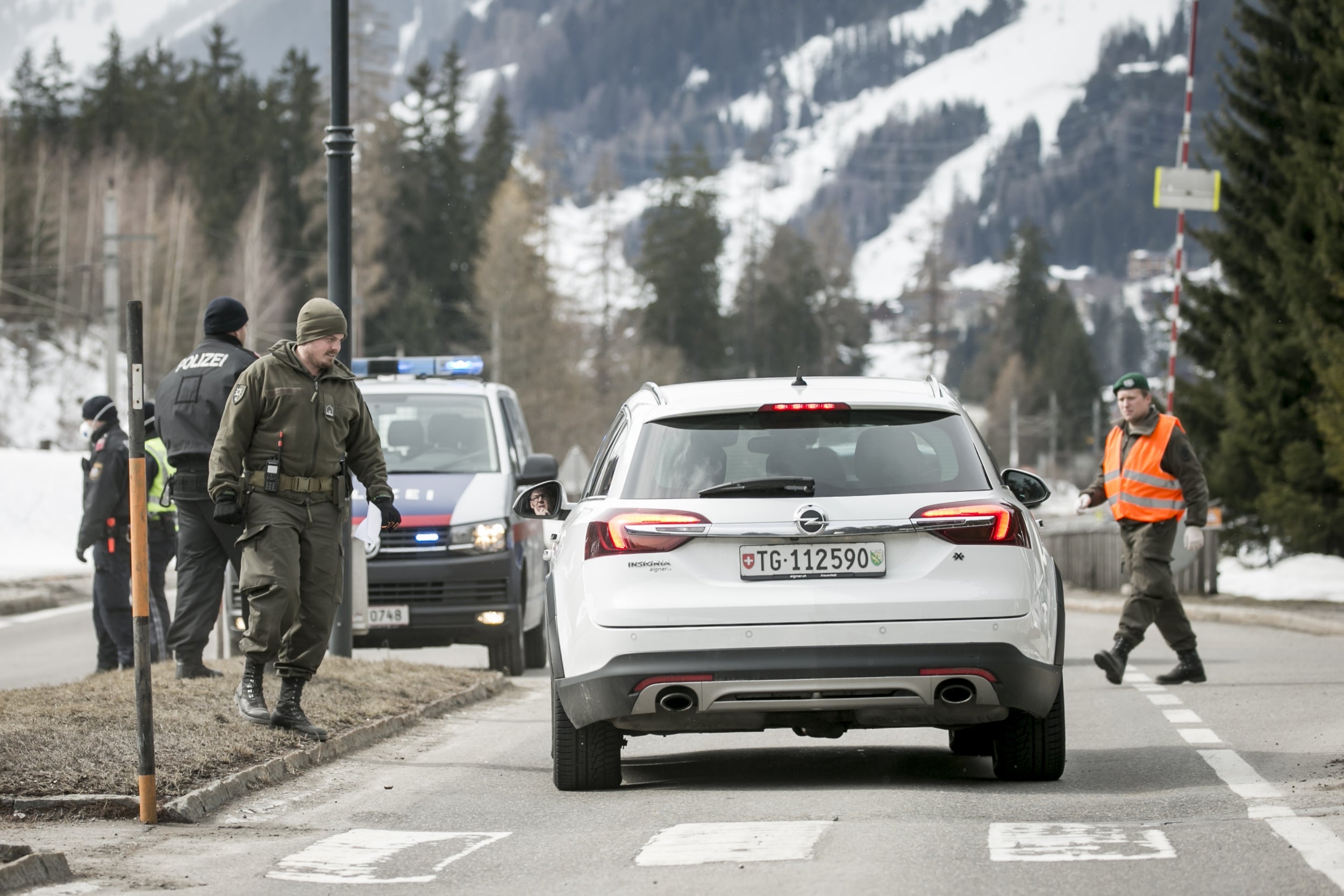 Authorities stop cars from leaving the quarantine zone around the resort