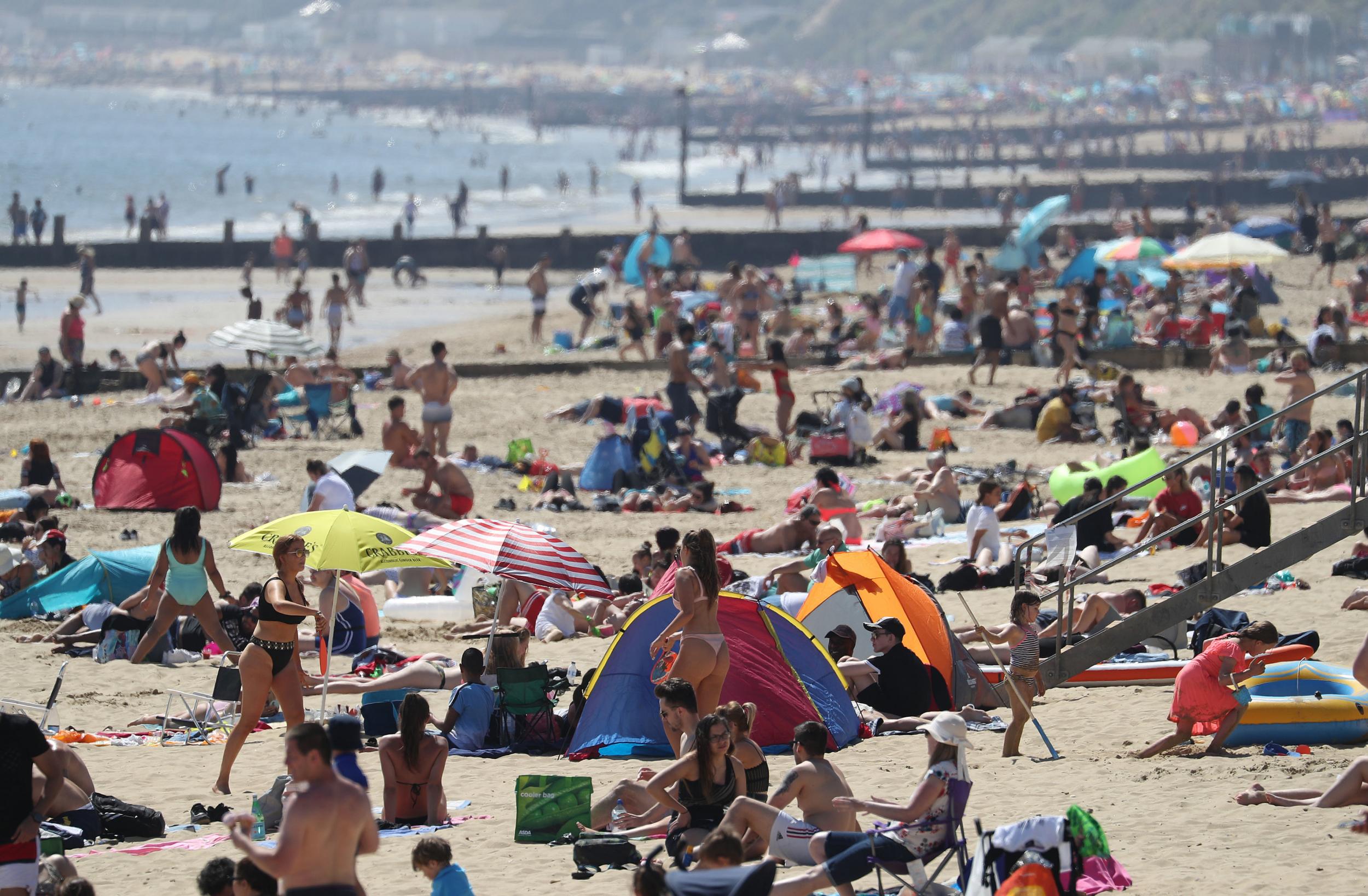 People enjoy the hot weather at Bournemouth beach in Dorset, as people flock to parks and beaches with lockdown measures eased