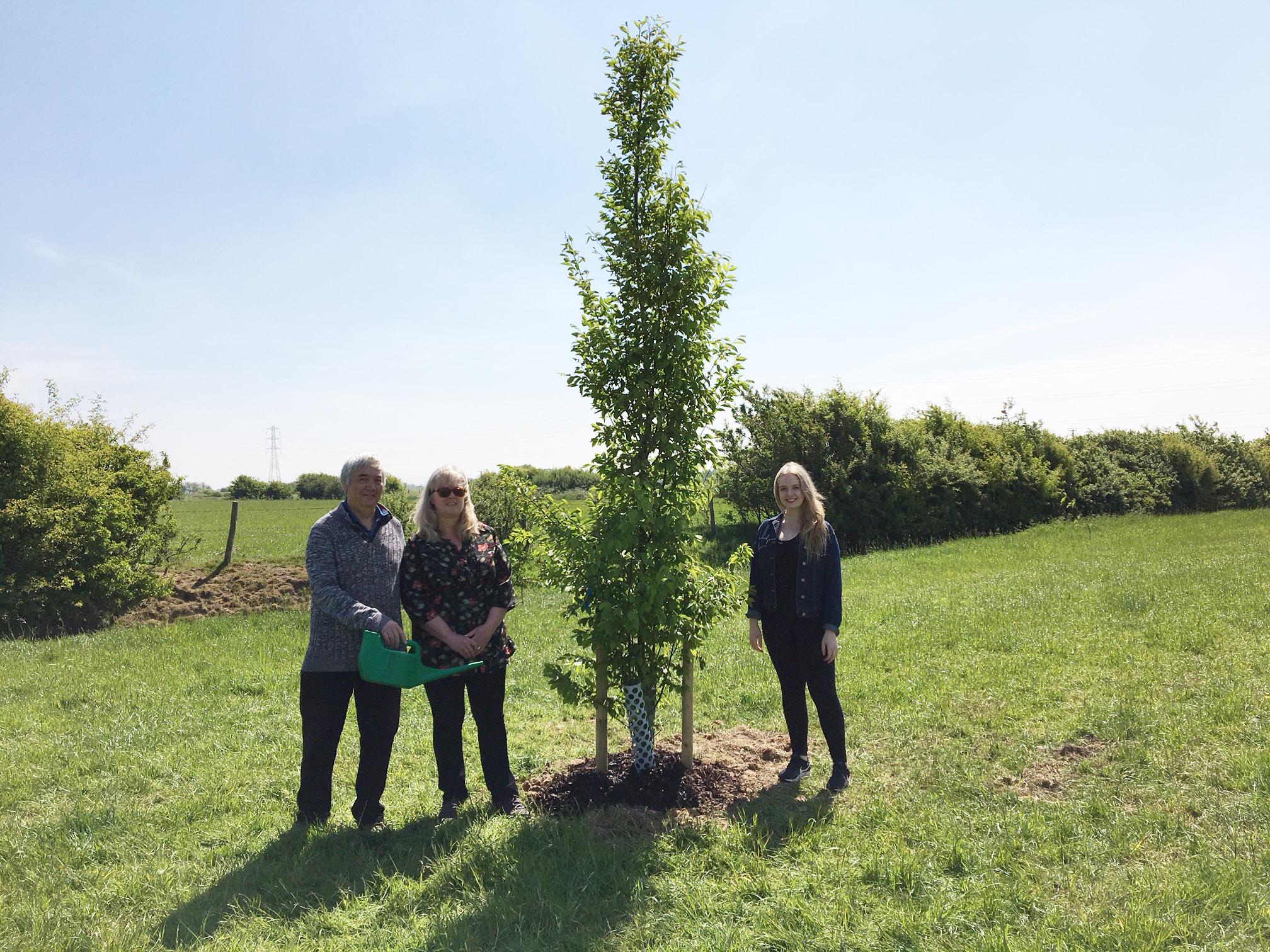 Malcolm and Sue Ybarras and daughter Natasha Godsiff with tree planted for Sue Fitton