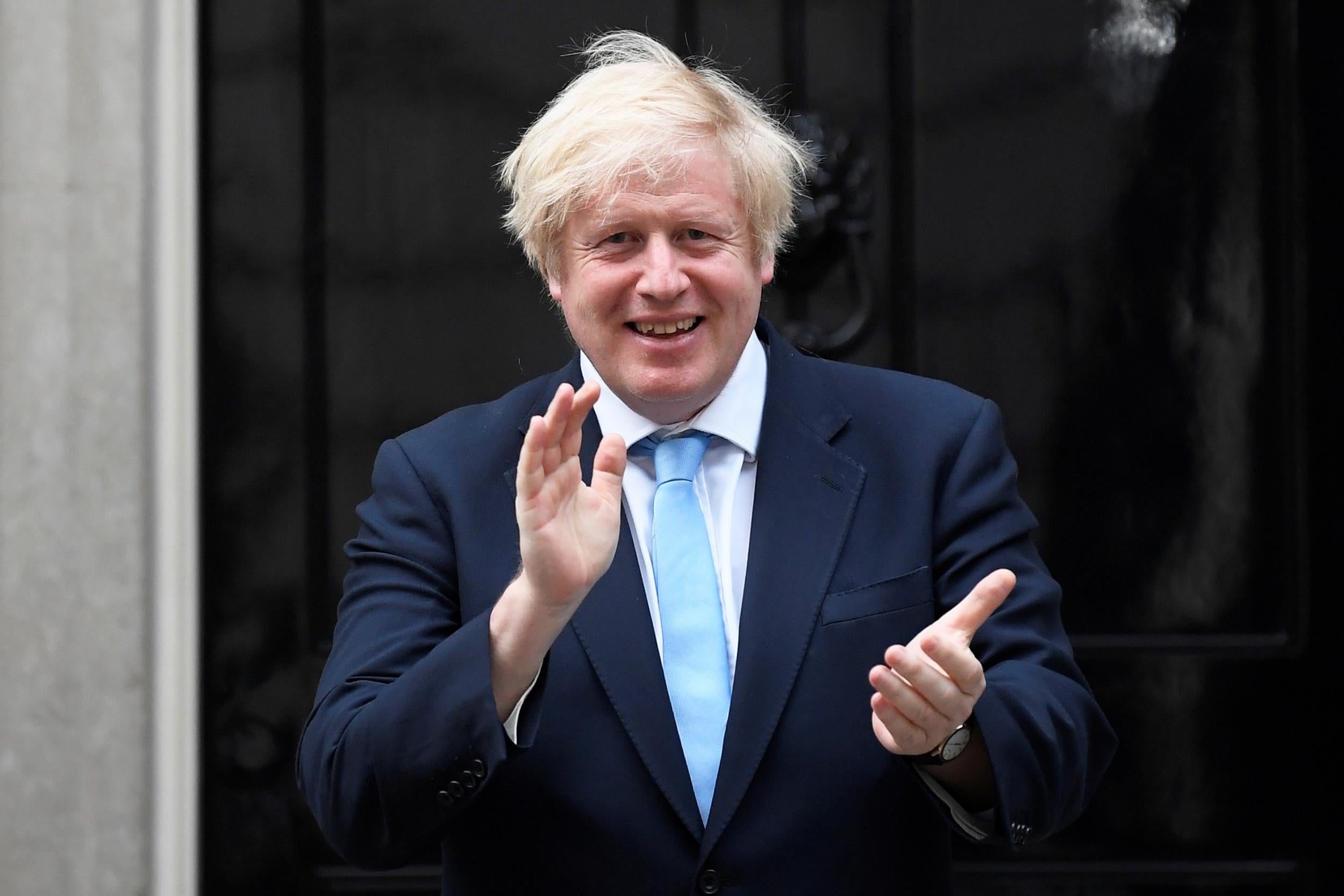 Britain’s Prime Minister Boris Johnson applauds outside 10 Downing Street during the Clap for our Carers