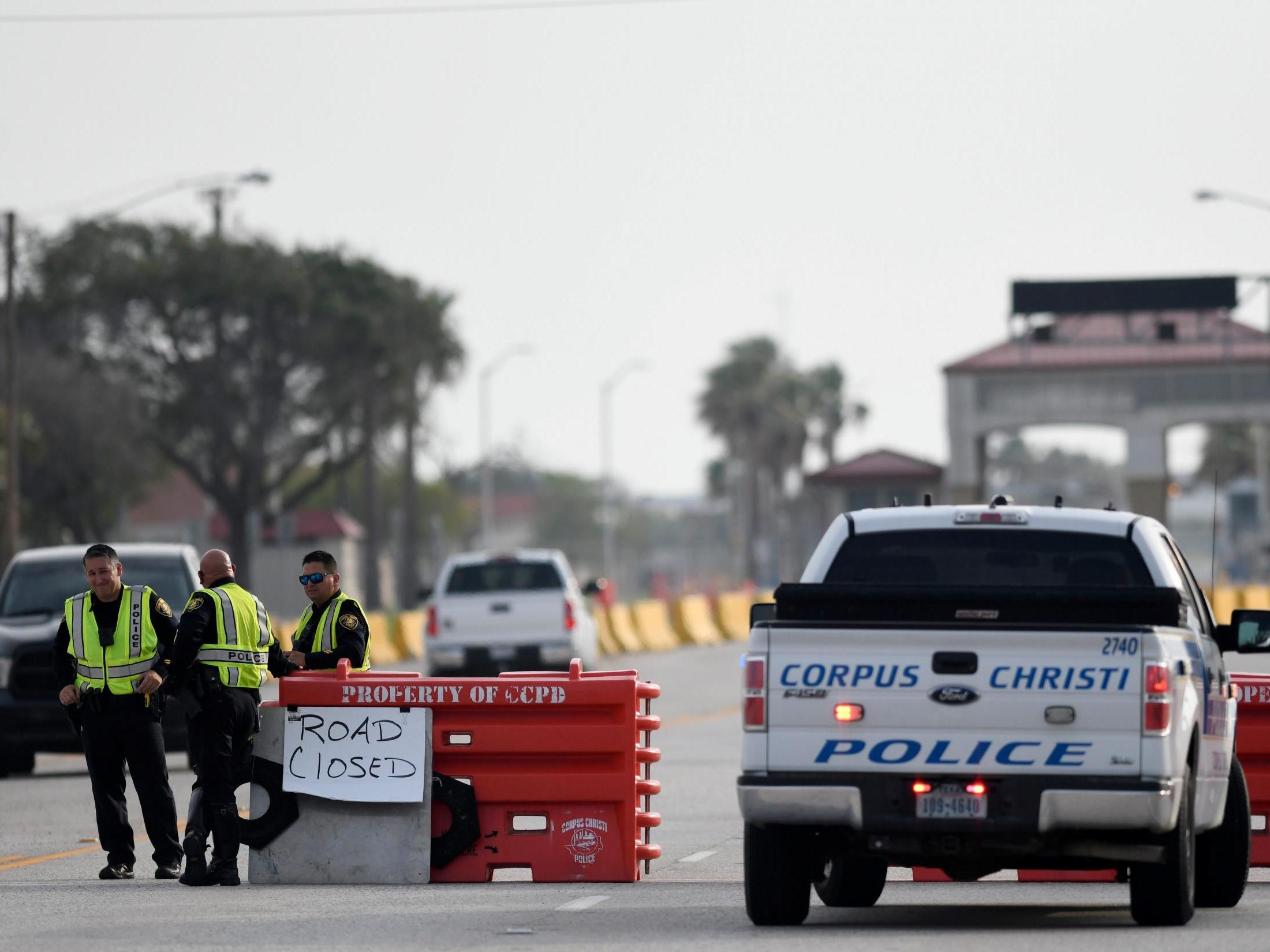 Police officers stand at a checkpoint after a shooting incident at Naval Air Station Corpus Christi, Texas