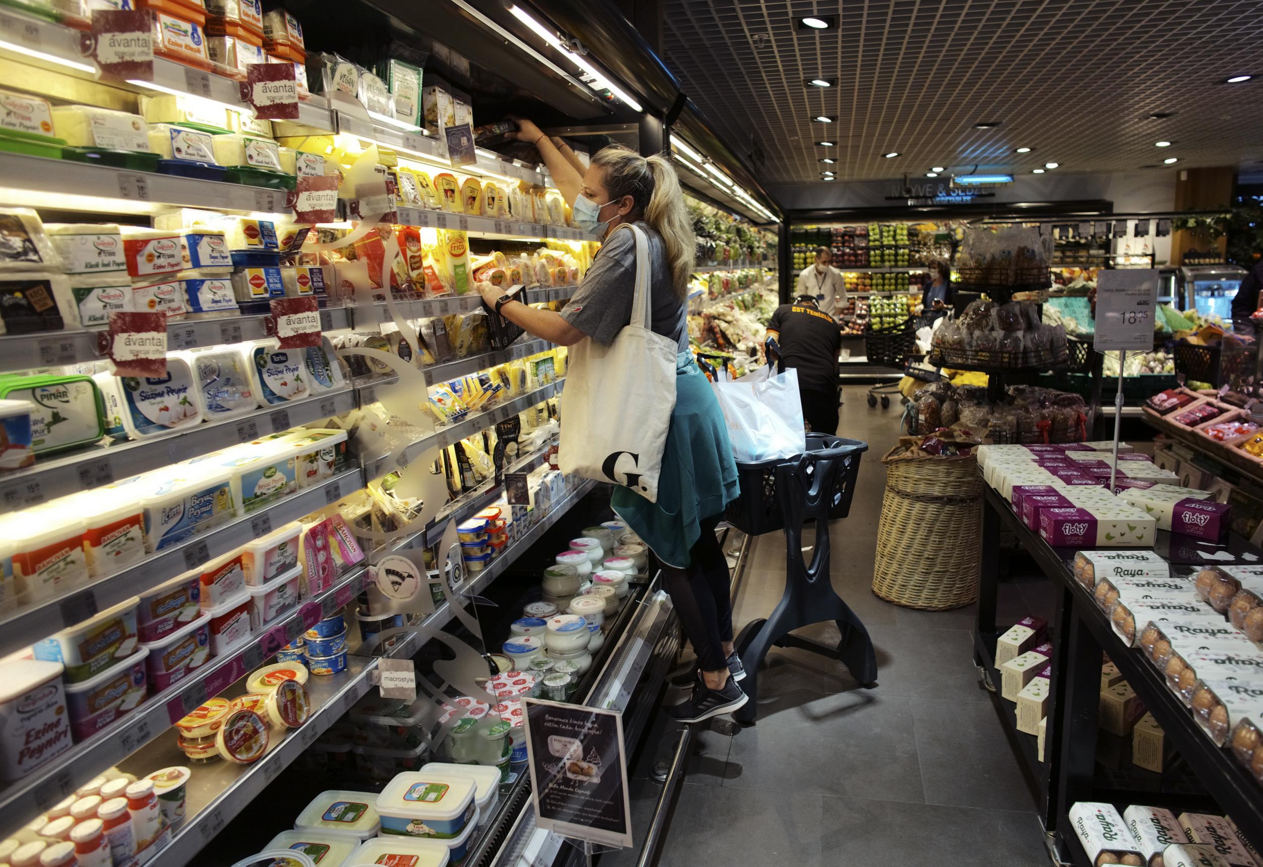 People wear face masks as they shop for groceries in Ankara