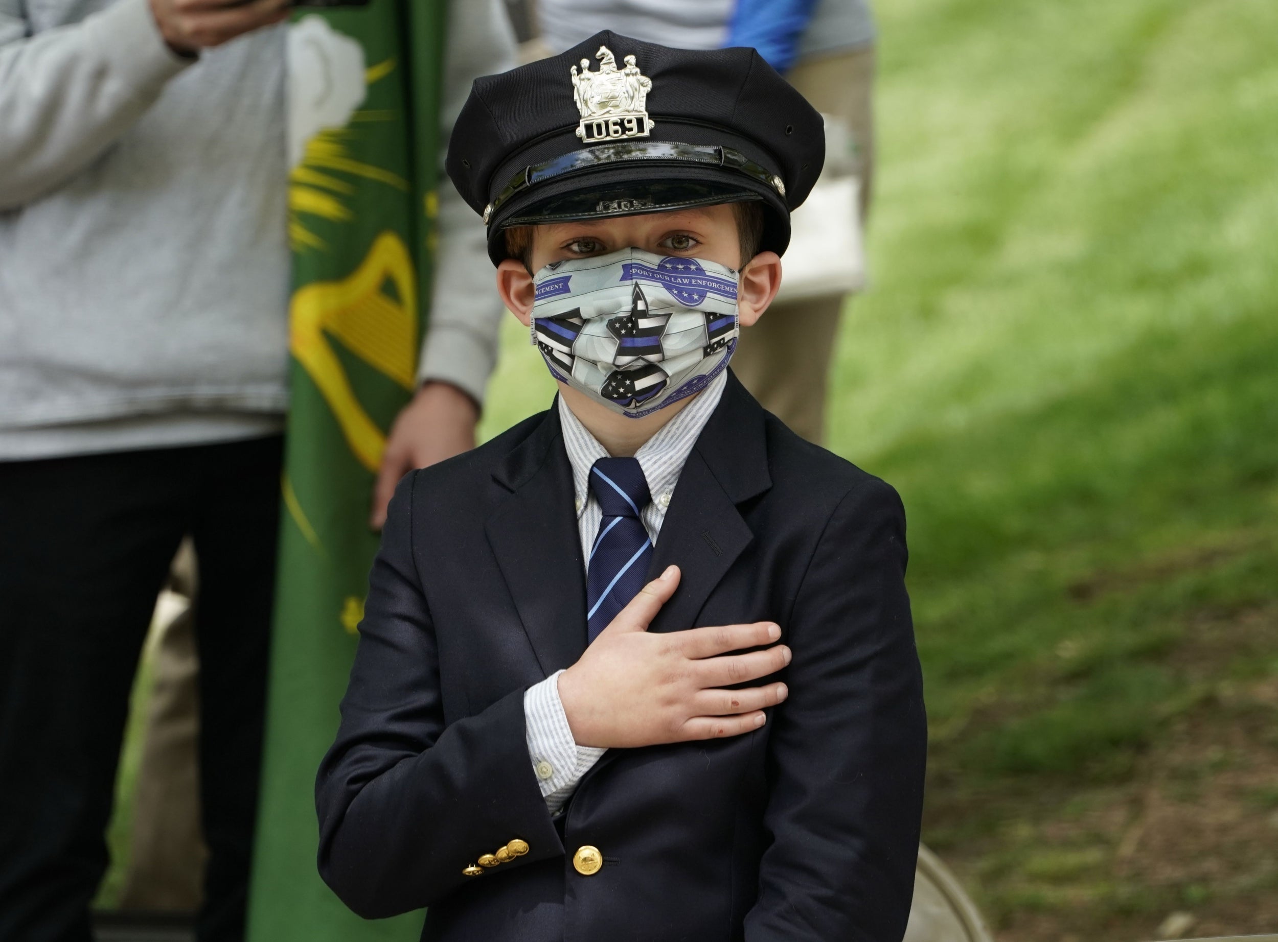 Gavin Roberts, 10, son of police officer Charles Rob Roberts, looks on during the funeral service of his father, who died of coronavirus weeks after contracting the disease while on duty, in Glen Ridge, New Jersey on May 14, 2020