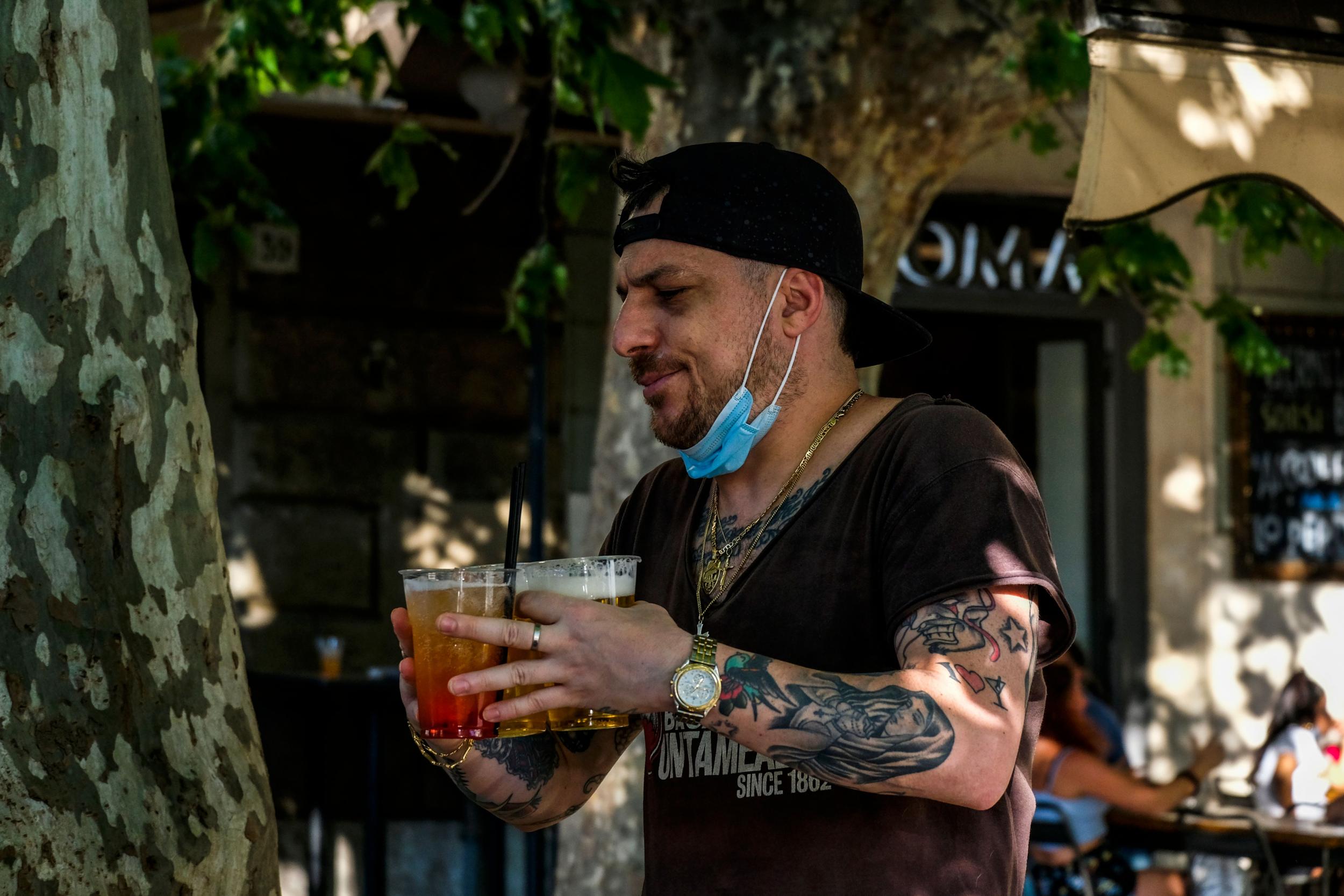 Governor of northern Veneto region shared a video on social media showing images of people shaking hands, having drinks with masks worn like necklaces, before cutting away to an image of somebody in a hospital bed