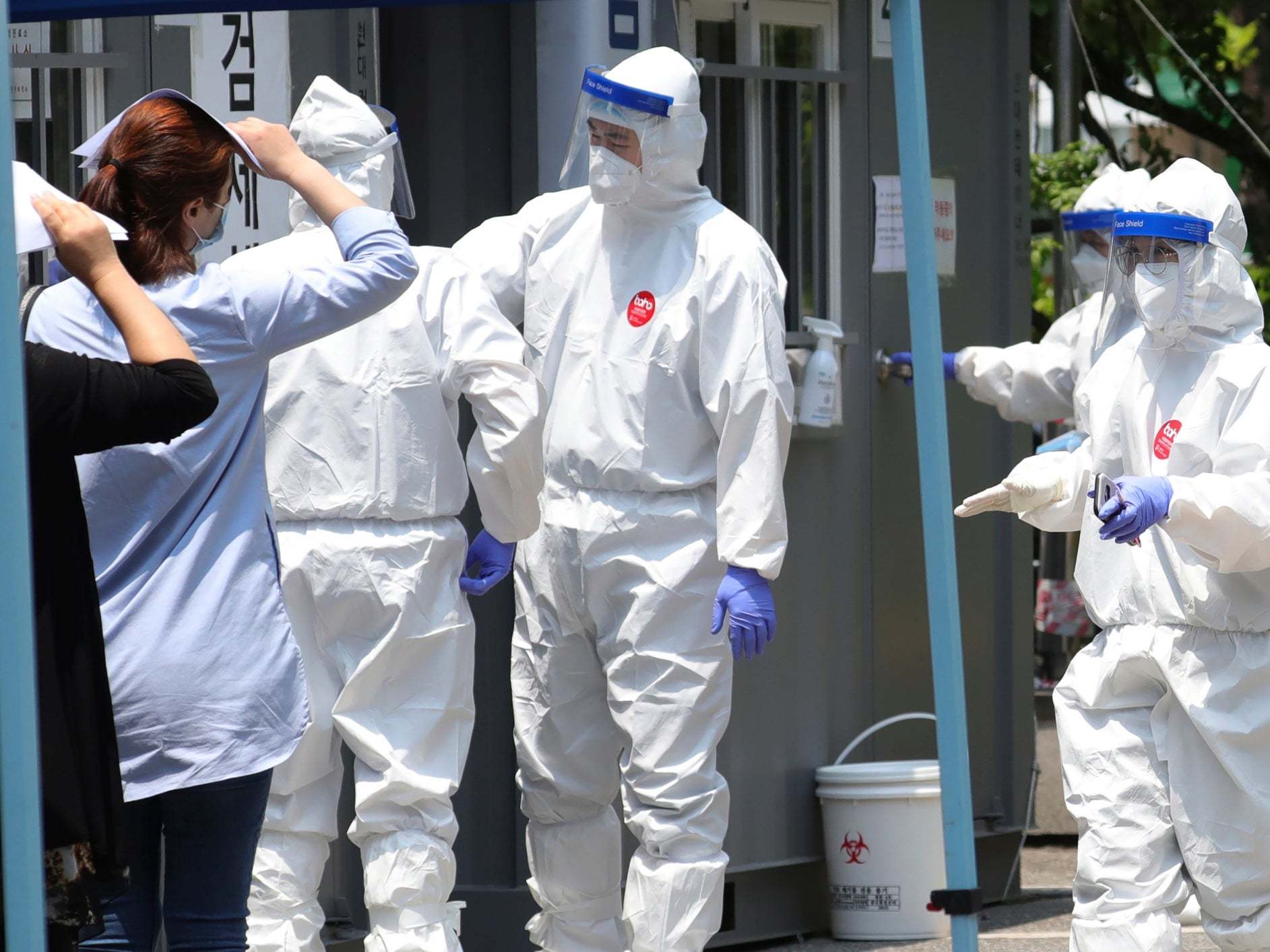 People suspected of being infected with the new coronavirus wait to receive tests at a coronavirus screening station in Bucheon, South Korea