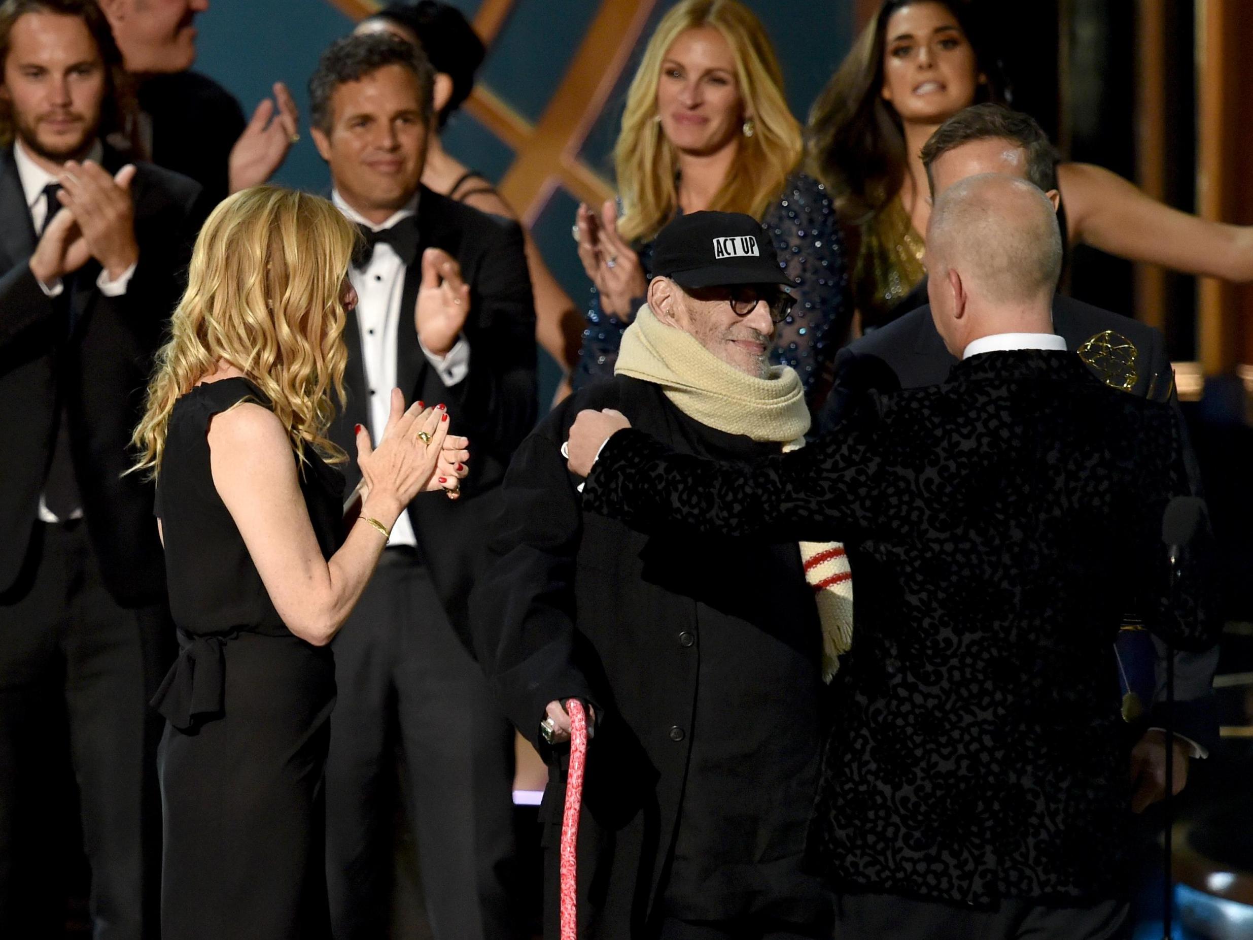 Kramer (centre) accepts the Outstanding Television Movie award at the Emmys in 2014